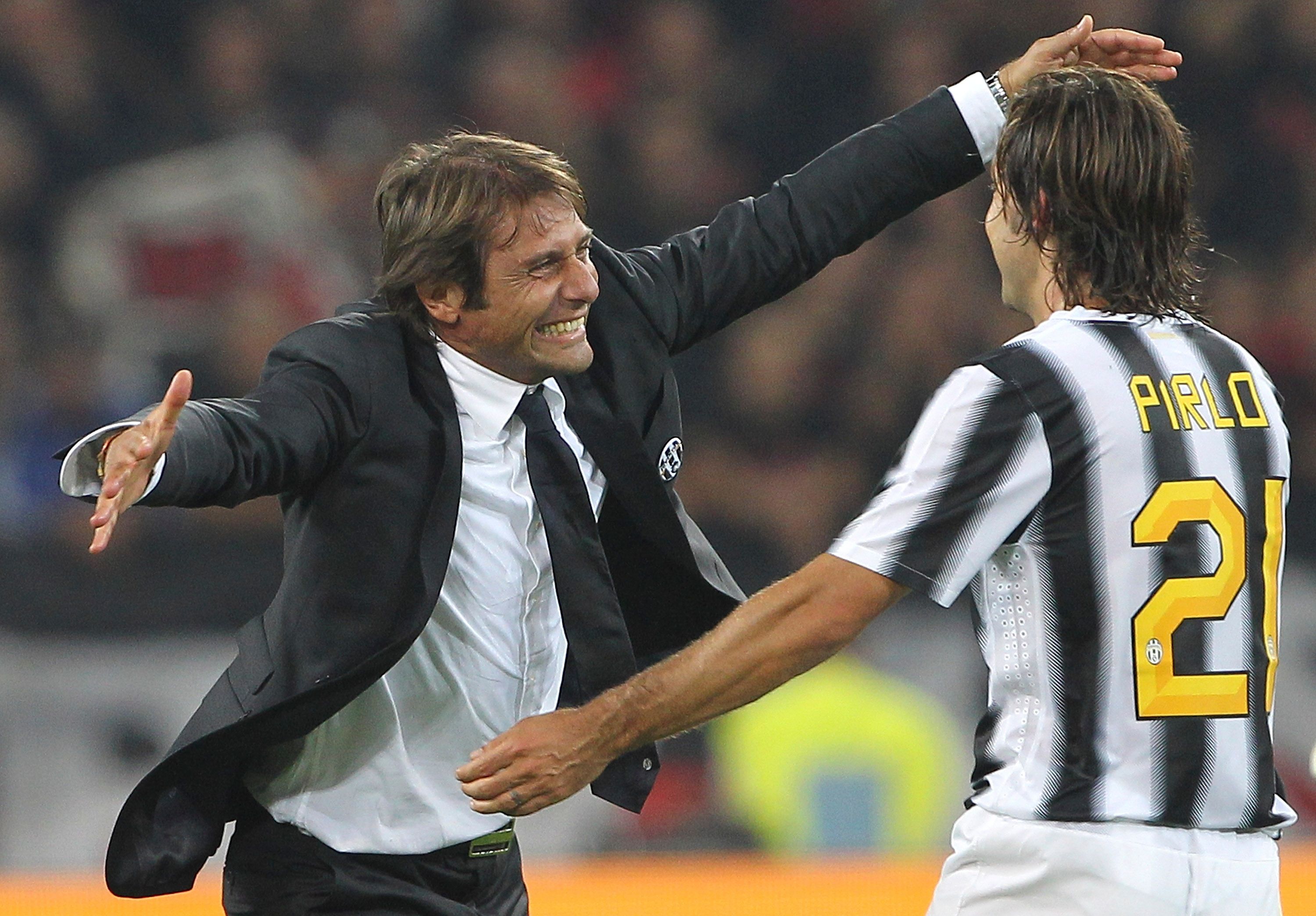 Antonio Conte (l) and Andrea Pirlo (r) embrace