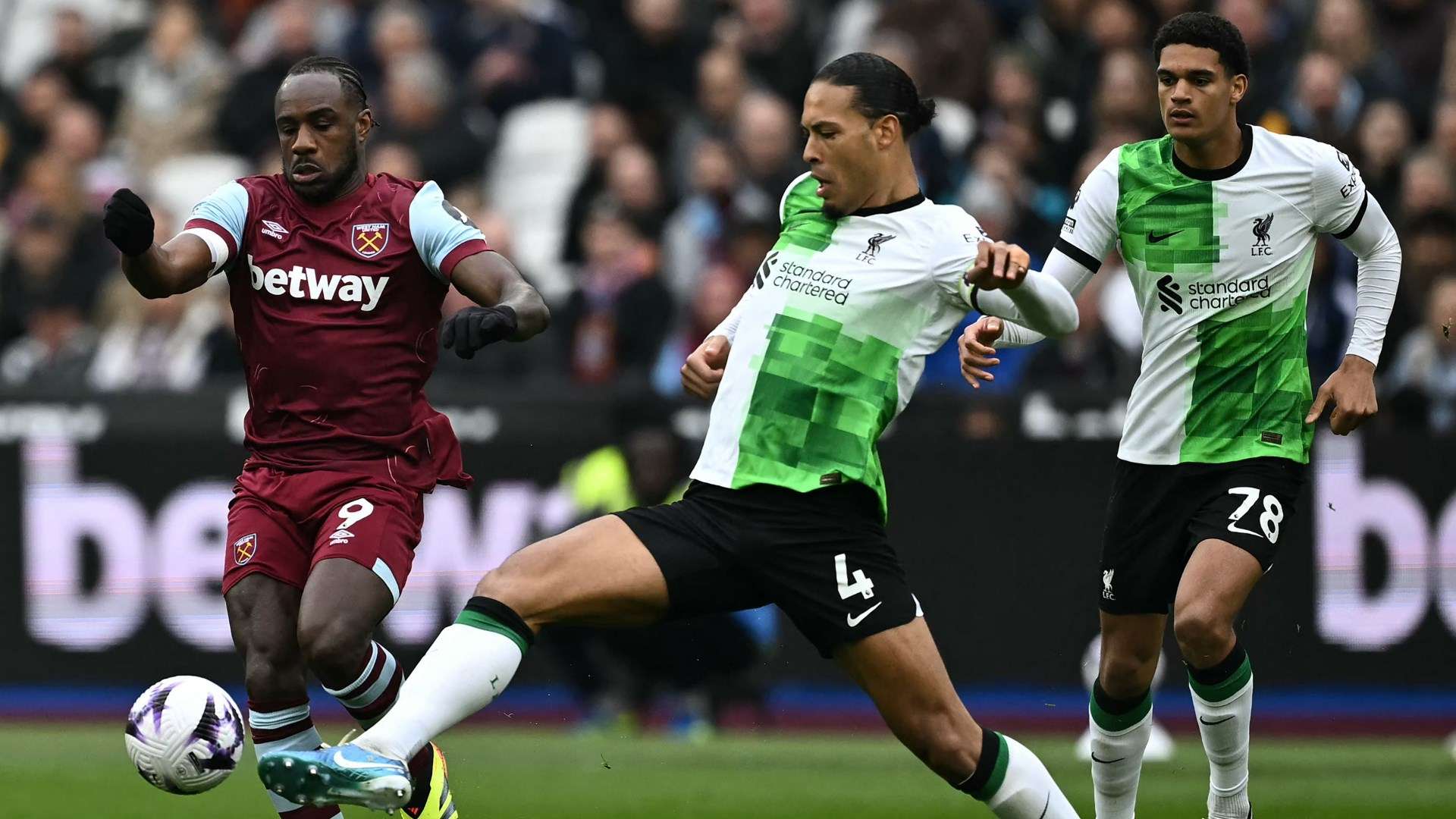 Michail Antonio and Virgil van Dijk battle for possession during West Ham's meeting with Liverpool 2023-24