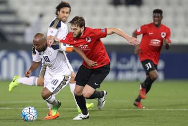 Al-Wahda's captain Ismaeil Matar (L) is tackled by Al-Rayyan's Nathan Otavio Ribeiro (C) during the Asian Champions League playoff football match between al-Rayyan and al-Wahda at the Jassim Bin Hamad Stadium in Doha on February 21