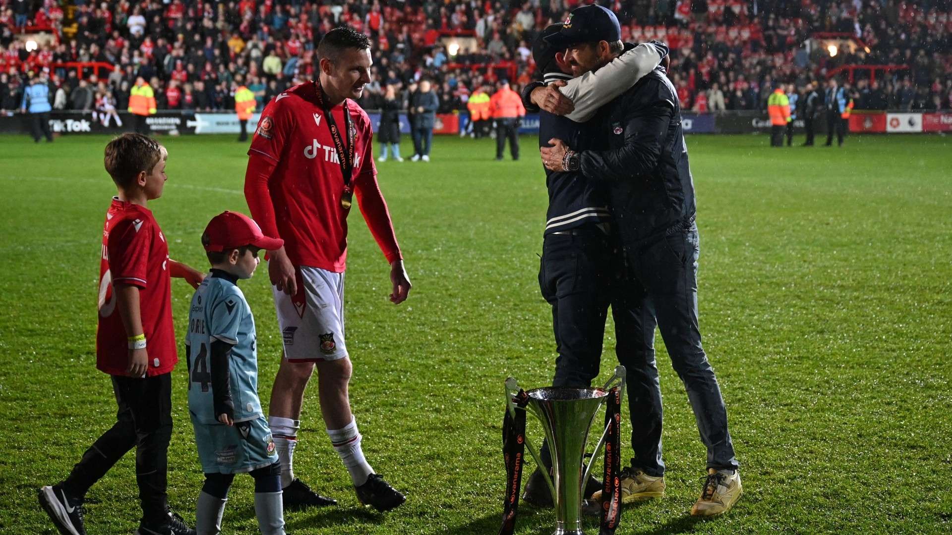 Paul Mullin Wrexham w/ son and trophy 2022-23