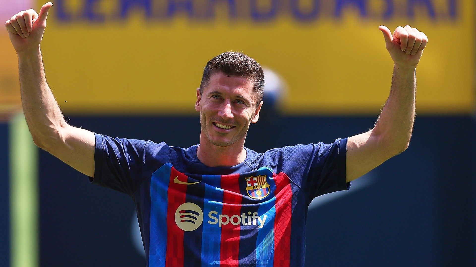 Robert Lewandowski poses for the media as he is presented as a FC Barcelona 