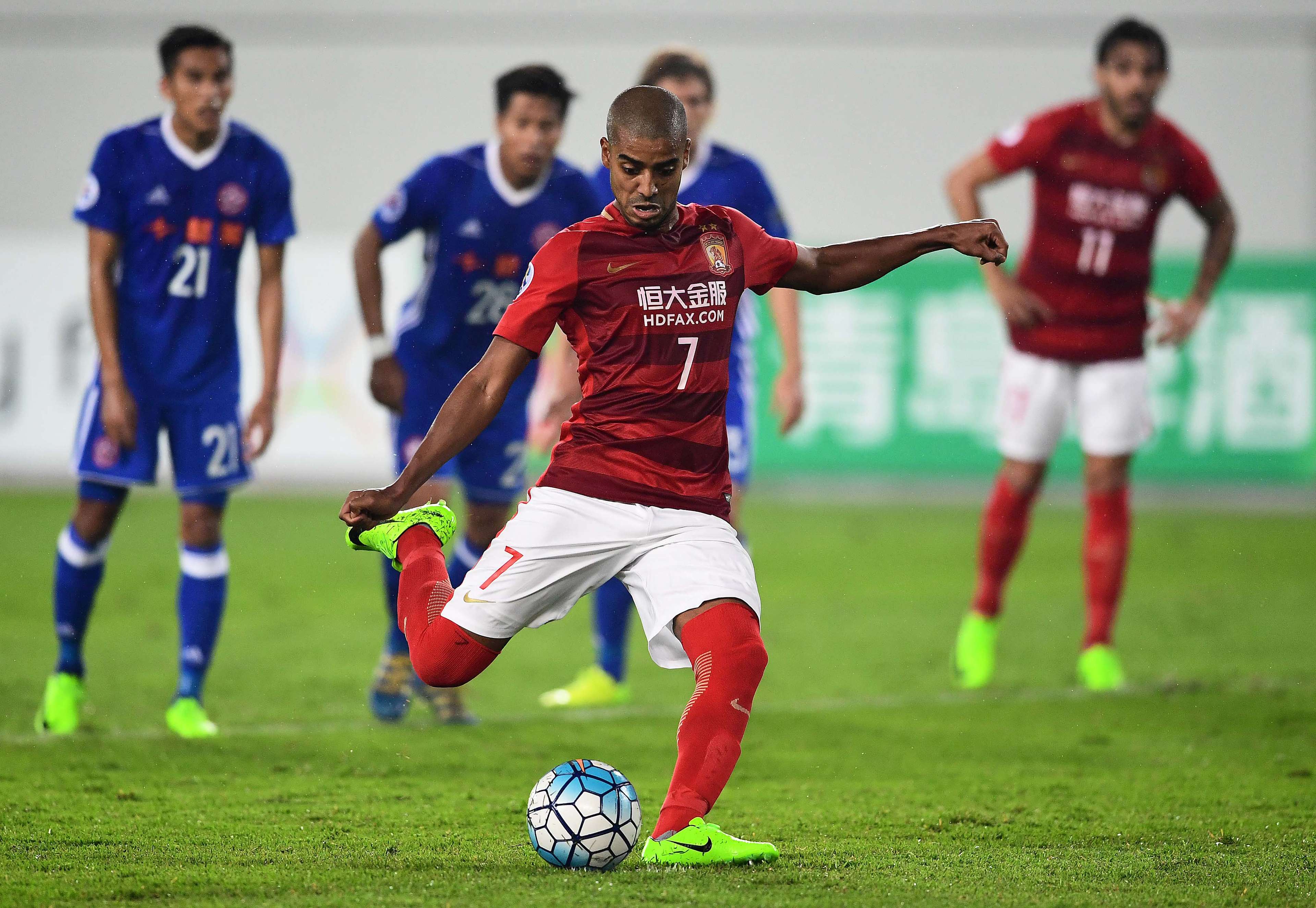 Alan Douglas de Carvalho of Guangzhou Evergrande takes a penalty during the team's AFC Champions League group stage football match against Eastern FC in Guangzhou