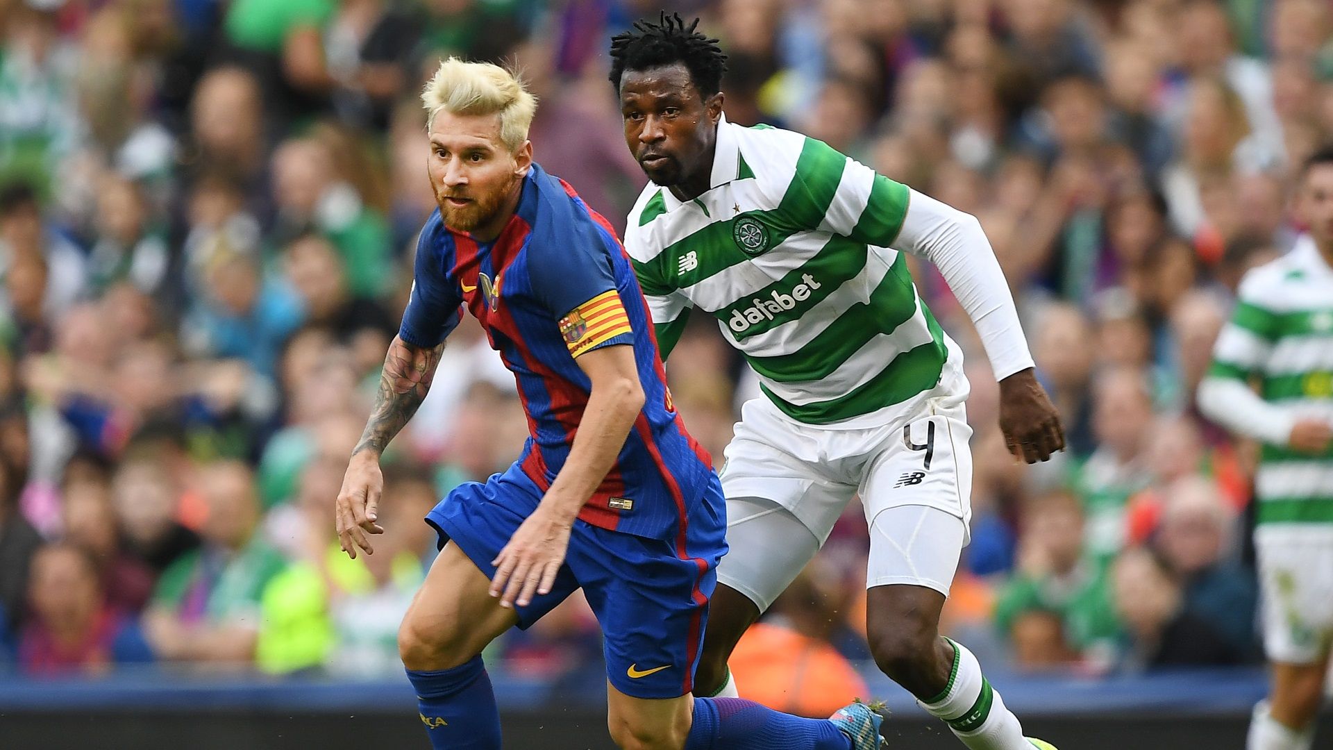 Lionel Messi of Barcelona and Efe Ambrose of Celtic