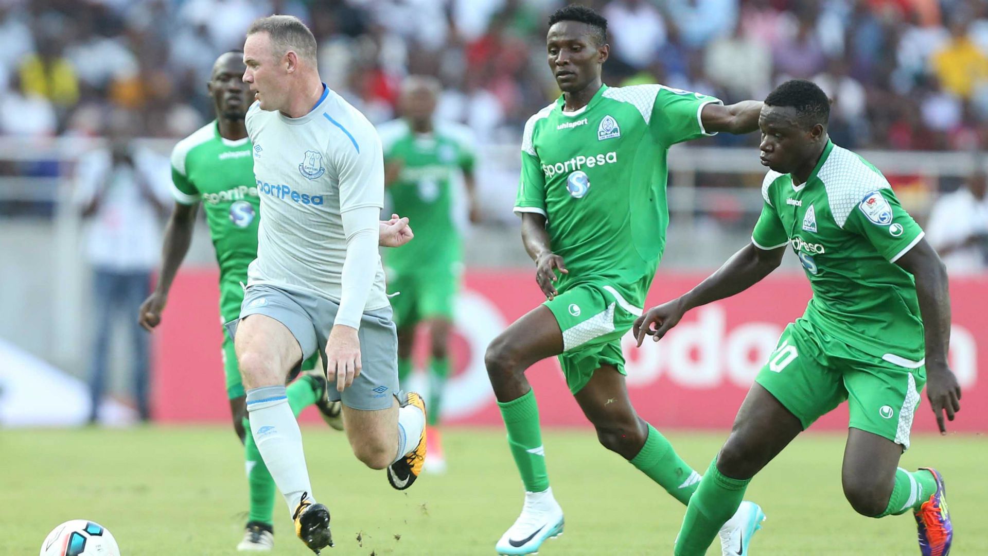 Wayne Rooney challenge Godfrey Walusimbi (L) Kenneth Muguna and Ernest Wendoo