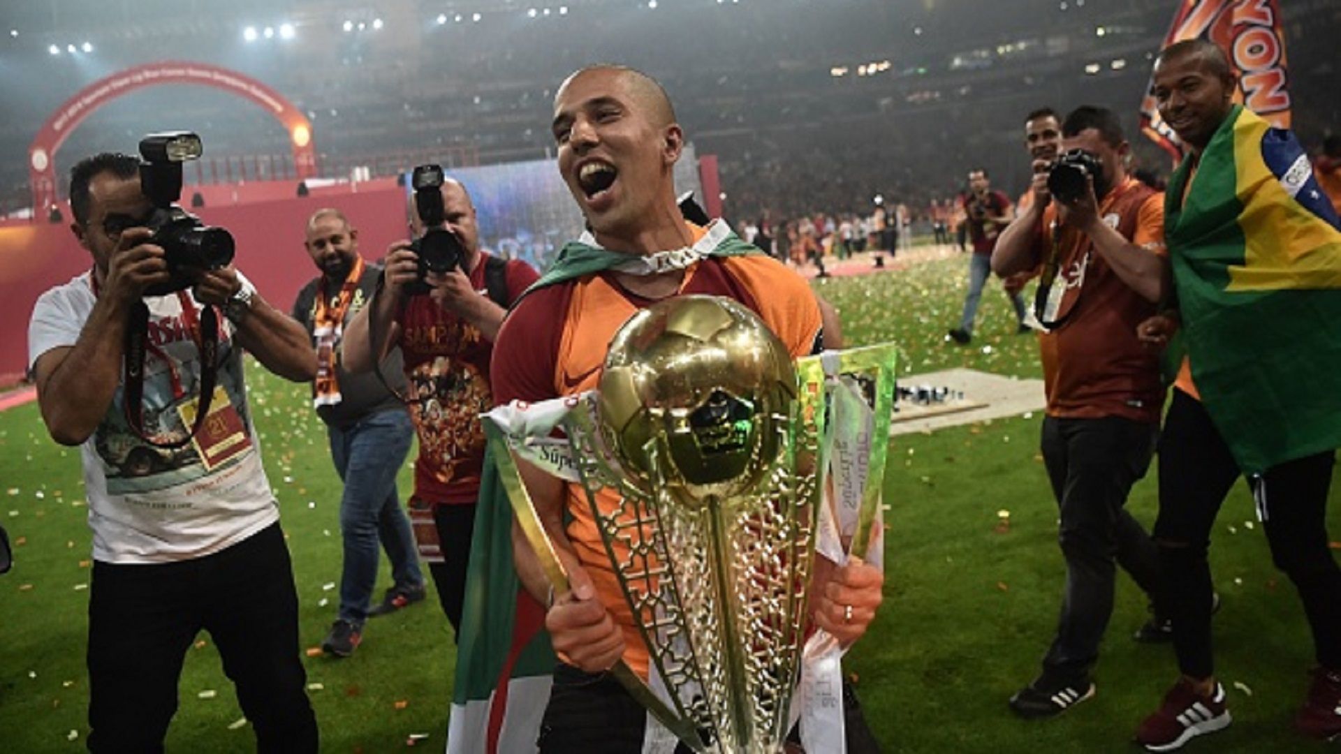 Galatasaray's midfielder Sofiane Feghouli poses with the 2017-2018 Turkish Super Lig title
