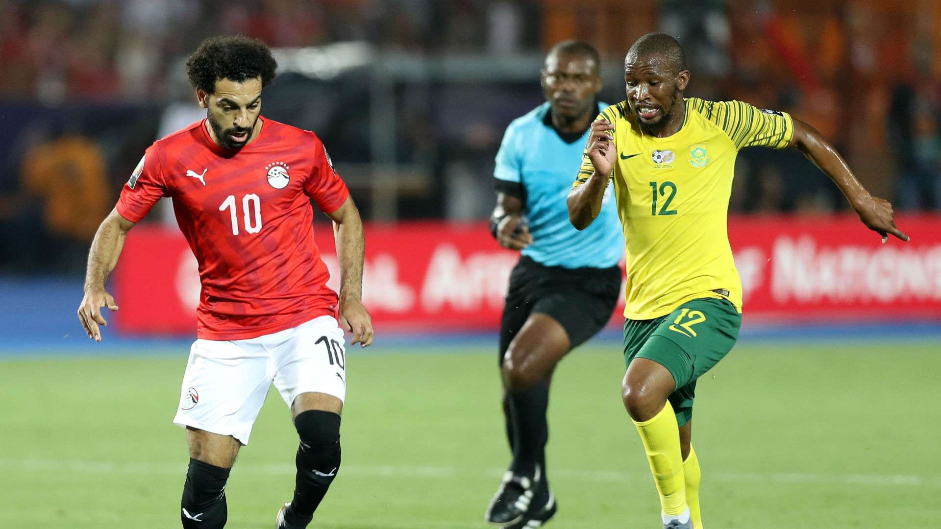 Mohamed Salah of Egypt challenged by Kamohelo Mokotjo of South Africa, July 2019