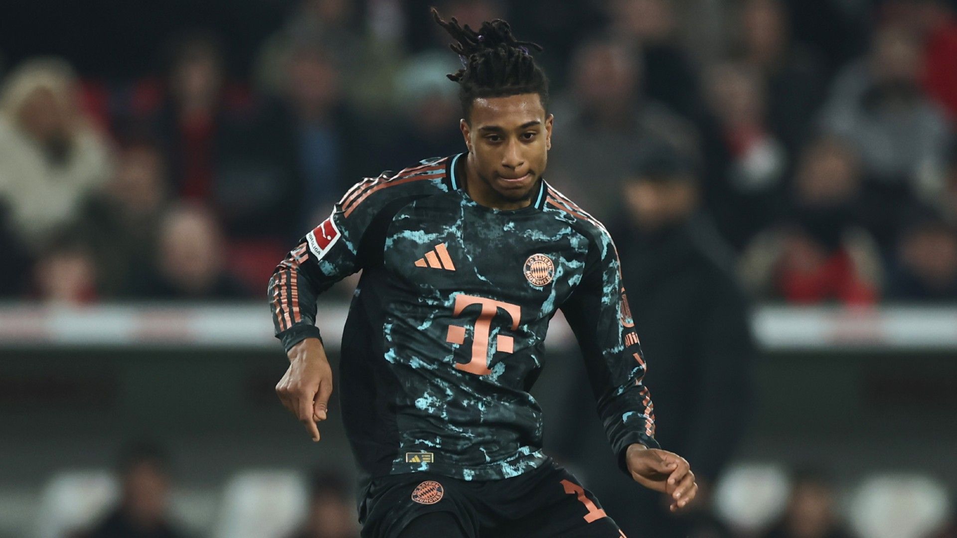 Michael Olise of Bayern Muenchen controls the ball