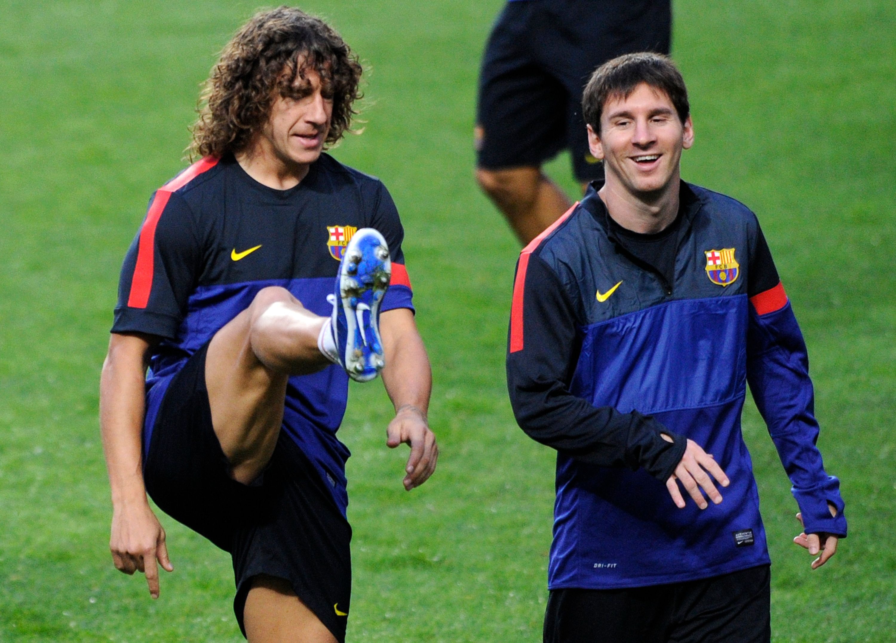 Barcelona's Carles Puyol and Lionel Messi in training