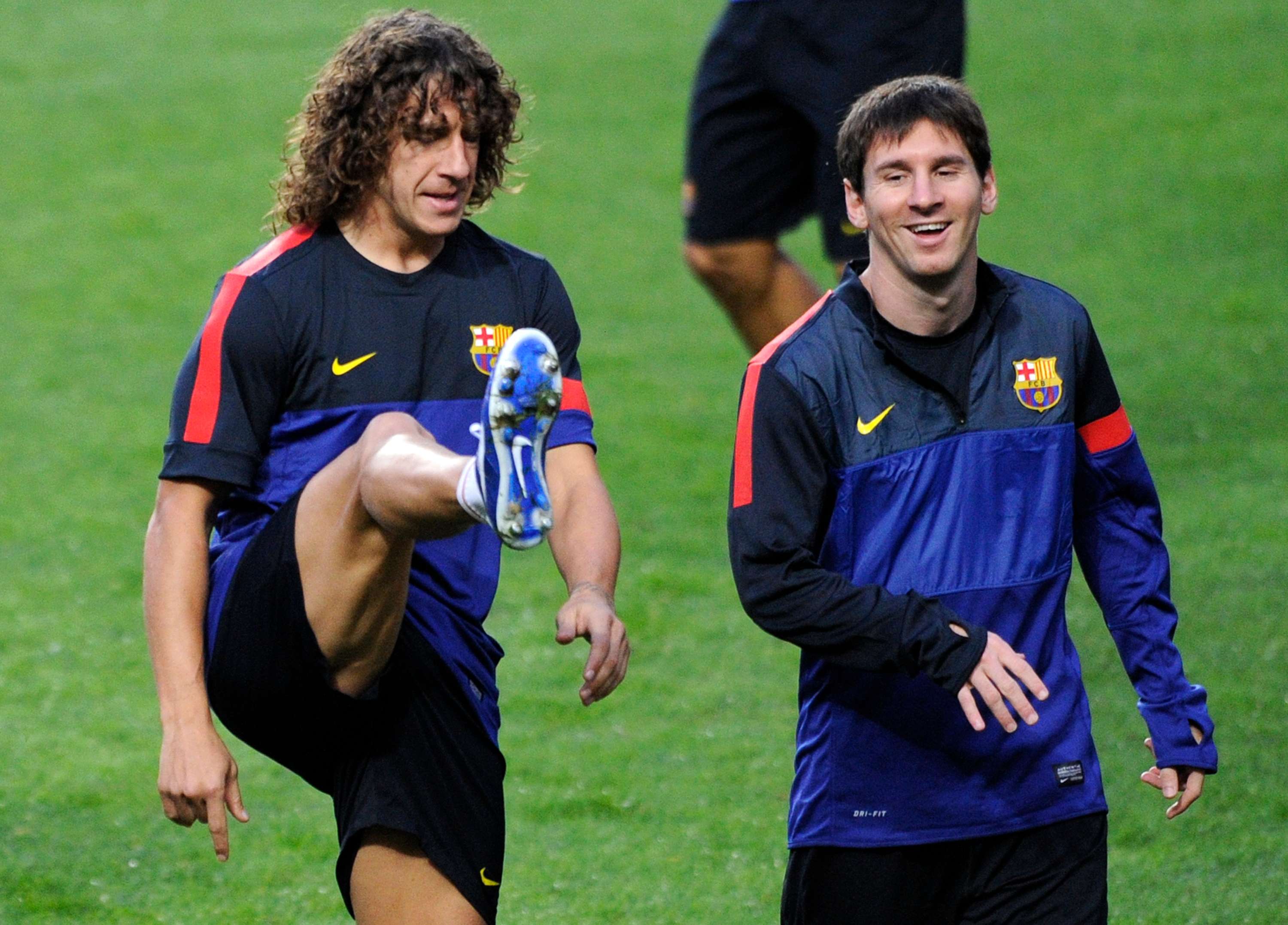 Barcelona's Carles Puyol and Lionel Messi in training