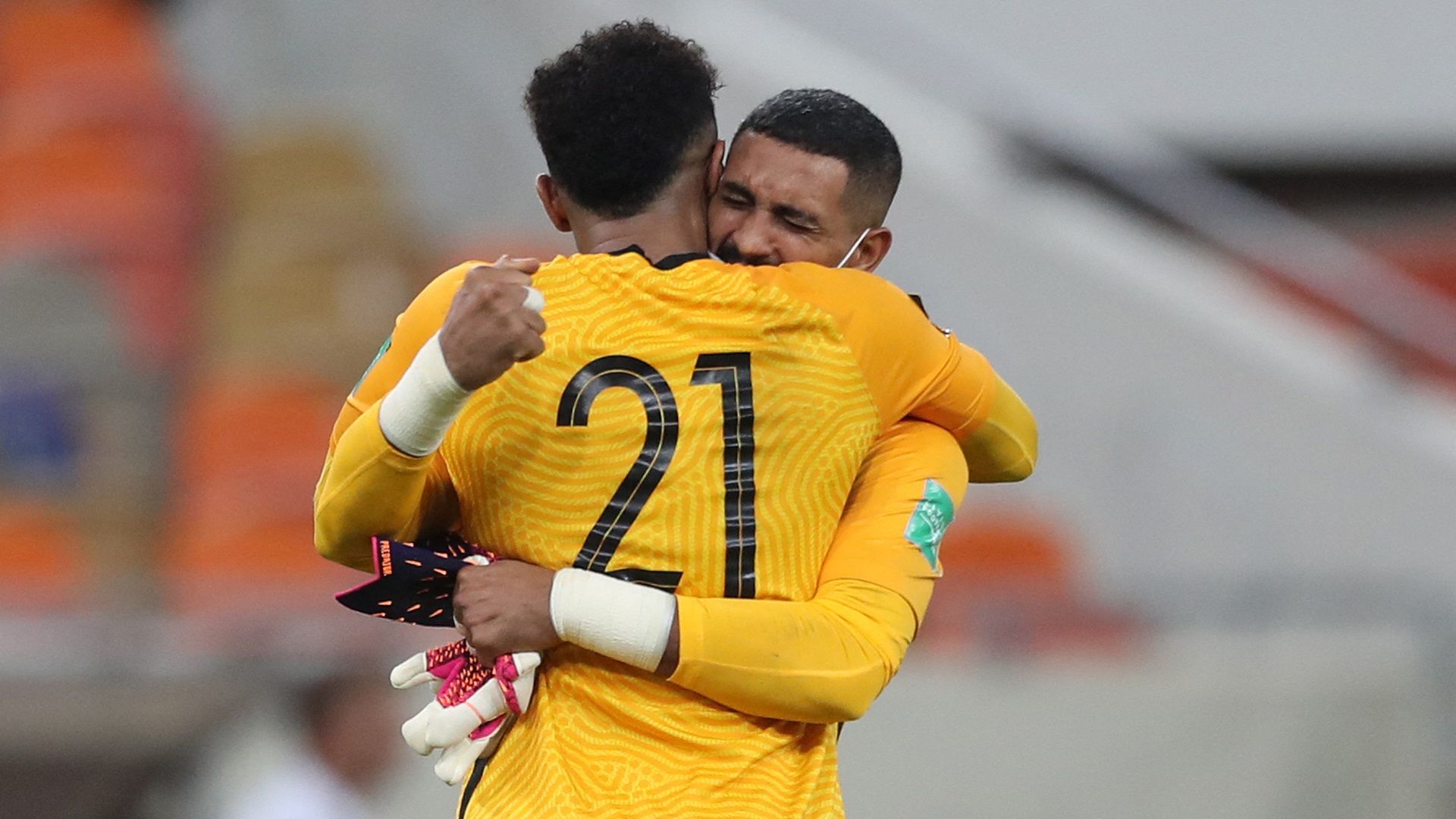 Saudi's goalkeeper Mohammed al-Owais (foreground) and Saudi's goalkeeper Fawaz al-Qarni celebrate after the 2022 Qatar World Cup Asian Qualifiers football match between Saudi Arabia and Japan