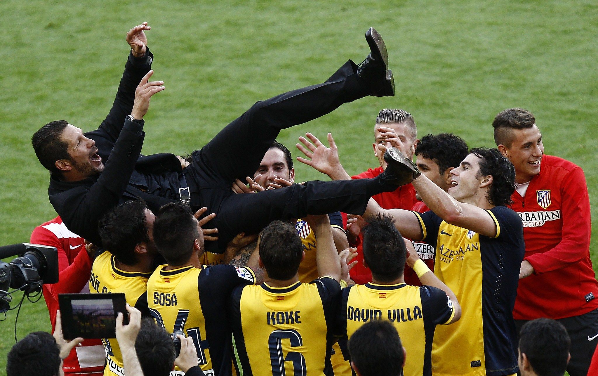 Atletico Madrid players celebrate their La Liga triumph with coach Diego Simeone