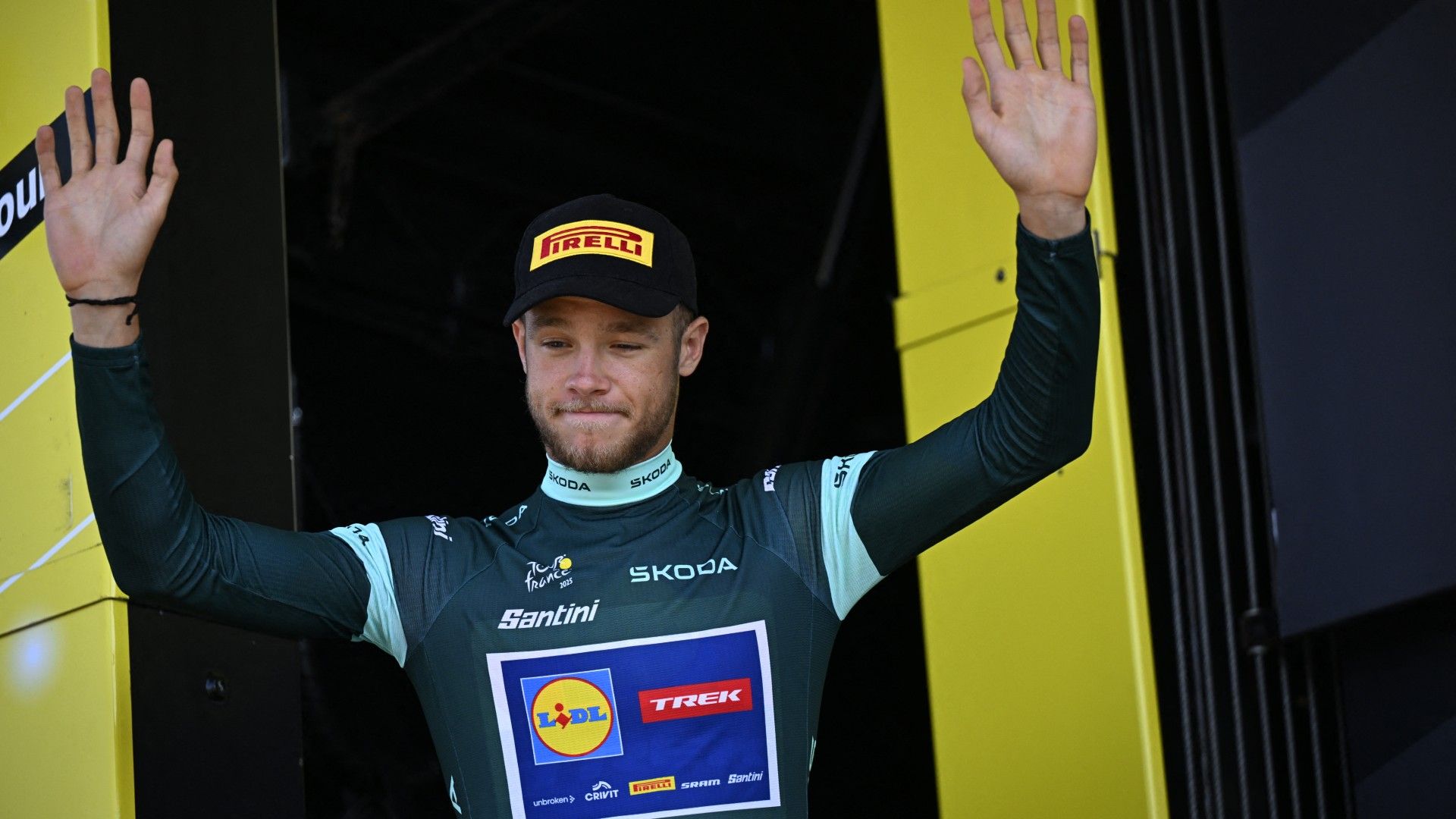Italian Jonathan Milan of Lidl-Trek celebrates on the podium in the green jersey of leader in the sprint ranking