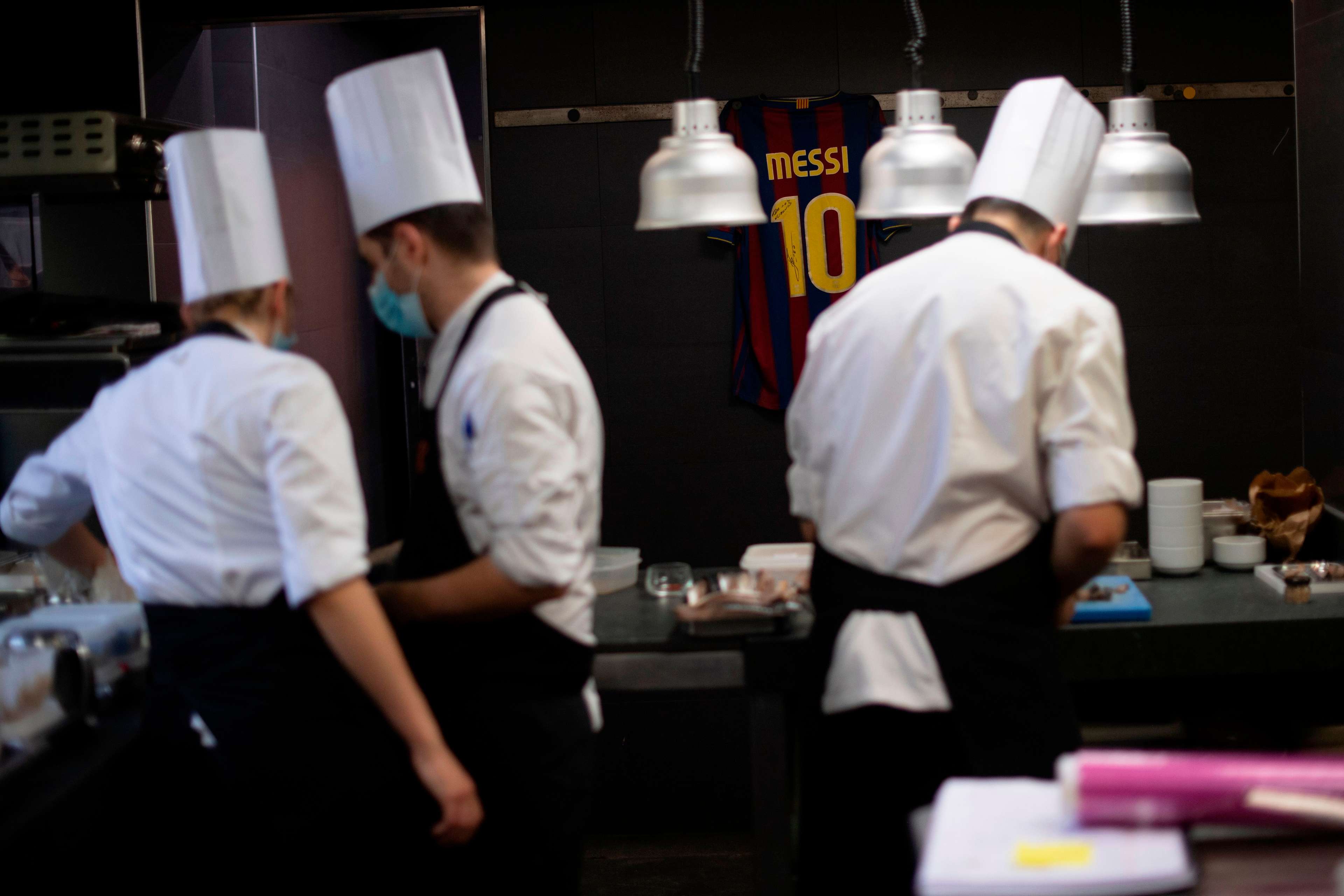 Chefs in kitchen with Messi shirt