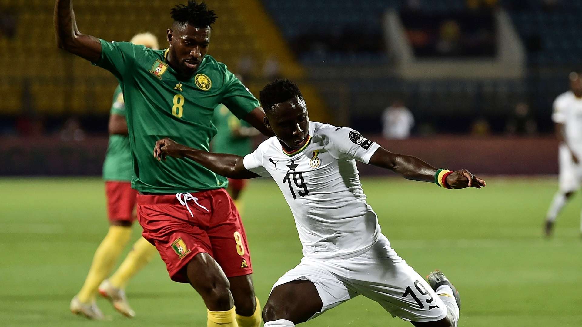 Ghana's midfielder Samuel Owusu prepares to take a shot as he is marked by Cameroon's midfielder Andre-Frank Zambo Anguissa during the 2019 Africa Cup of Nations