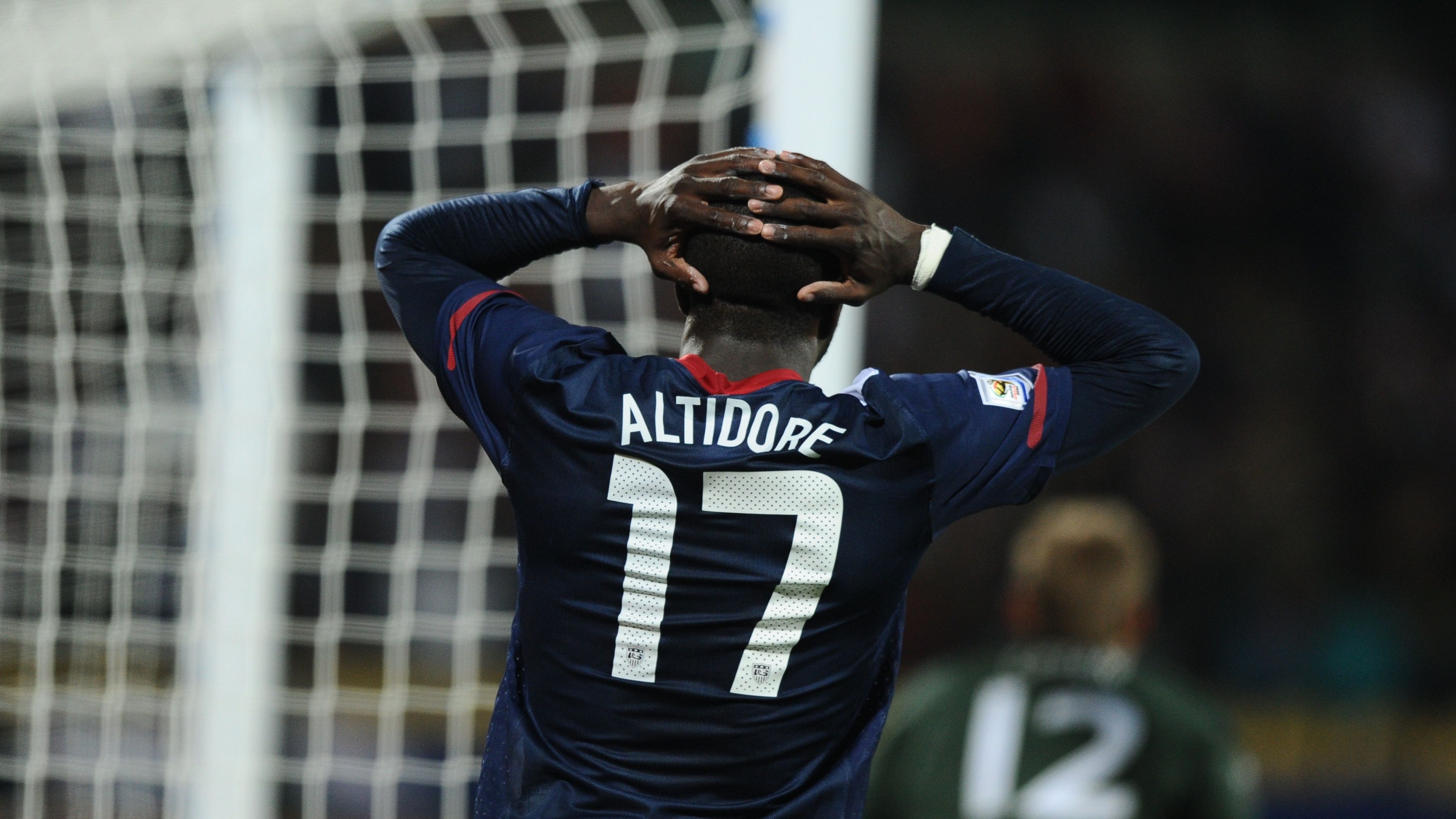 US striker Jozy Altidore reacts after mi