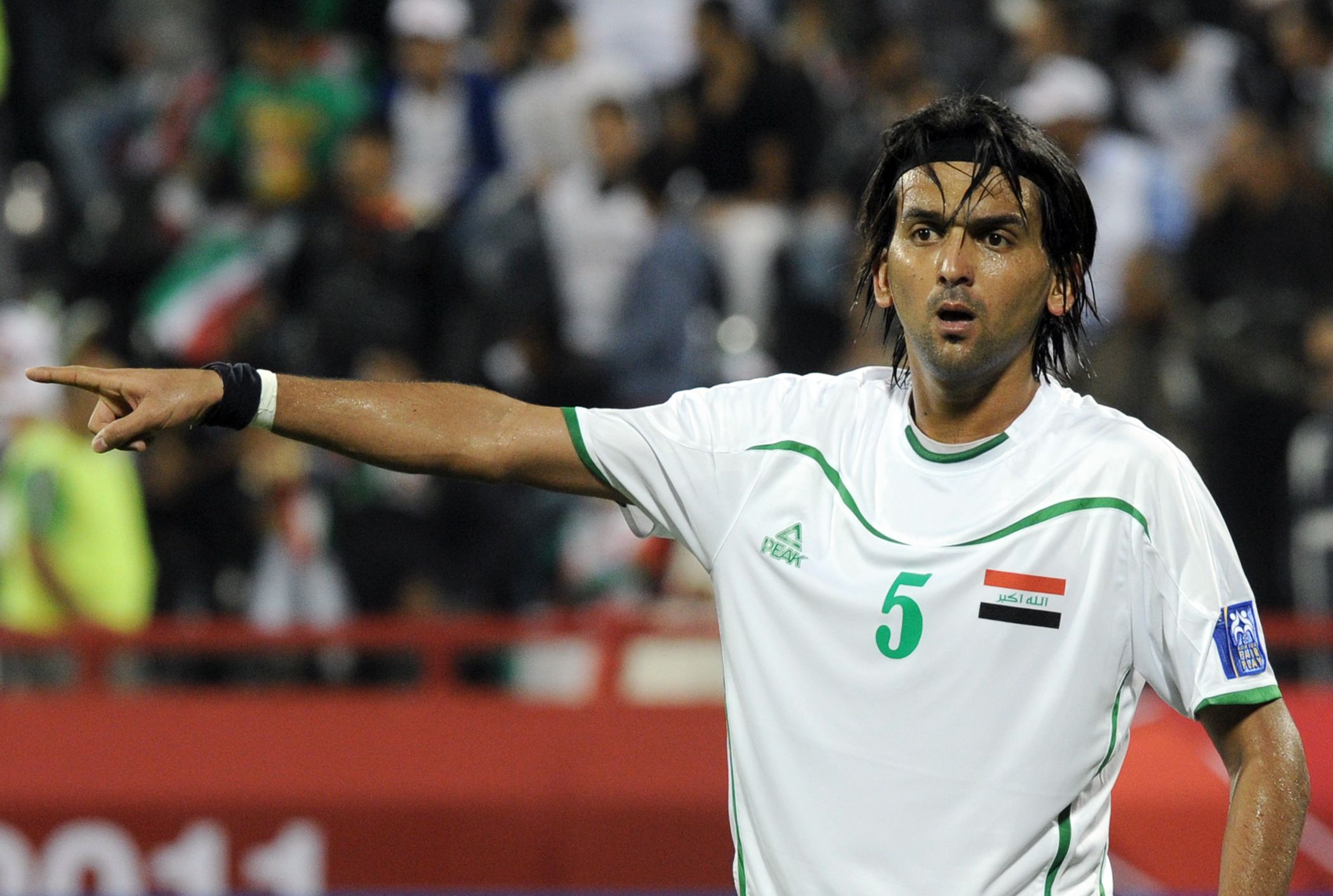 Iraq's midfielder Nashat Akram gestures