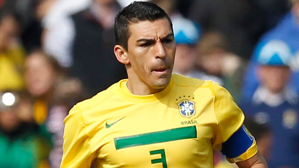 Brazil's Captain Lucio runs with the bal