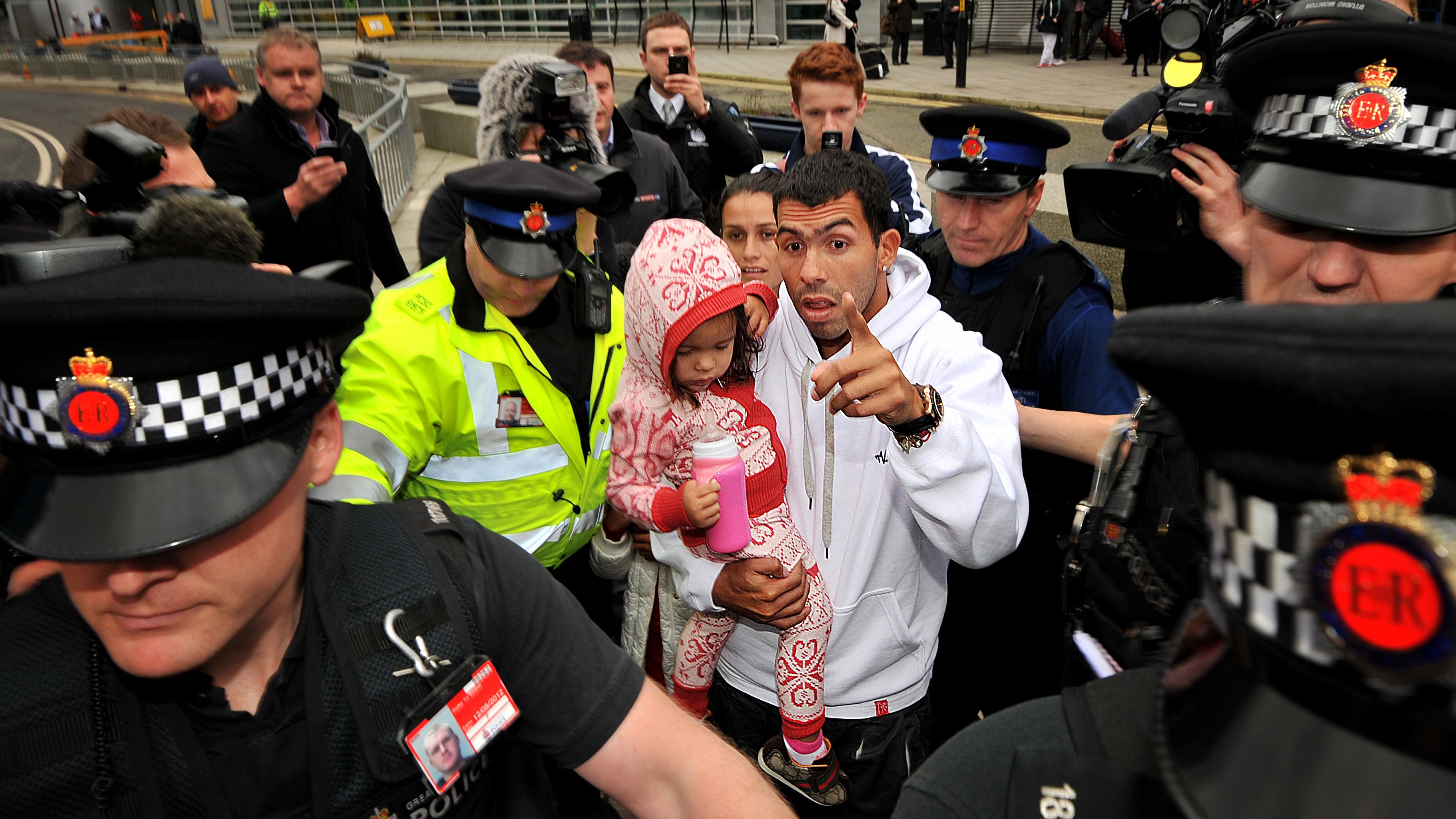 Police escort Manchester City's Argentin