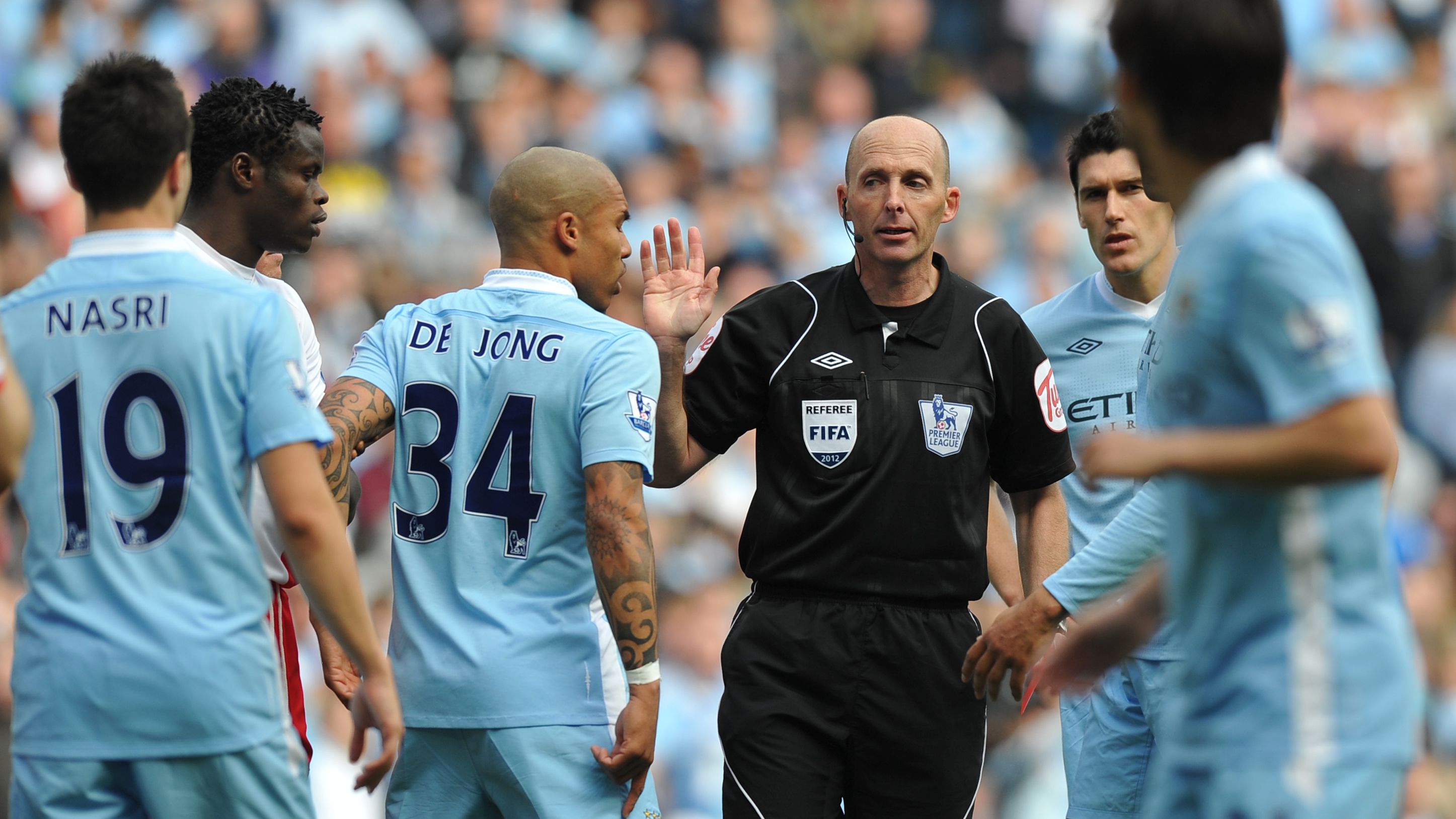 Manchester City's players surround the r