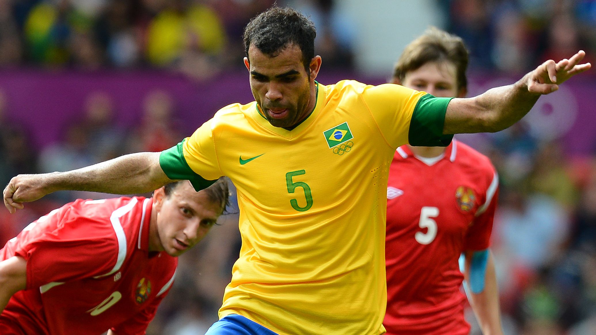 Brazil's midfielder Sandro (C) controls 
