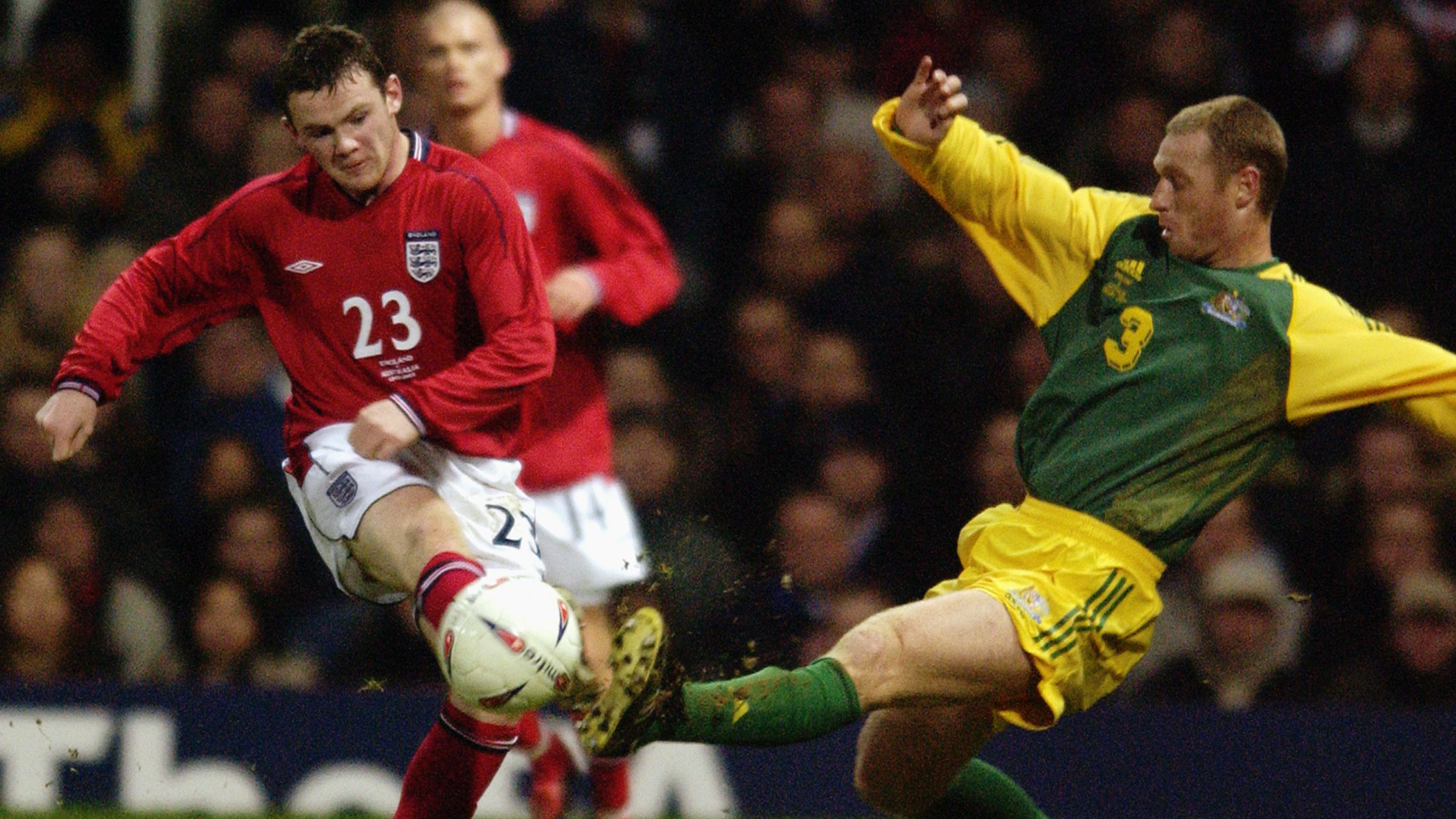 Wayne Rooney of England and Craig Moore of Australia