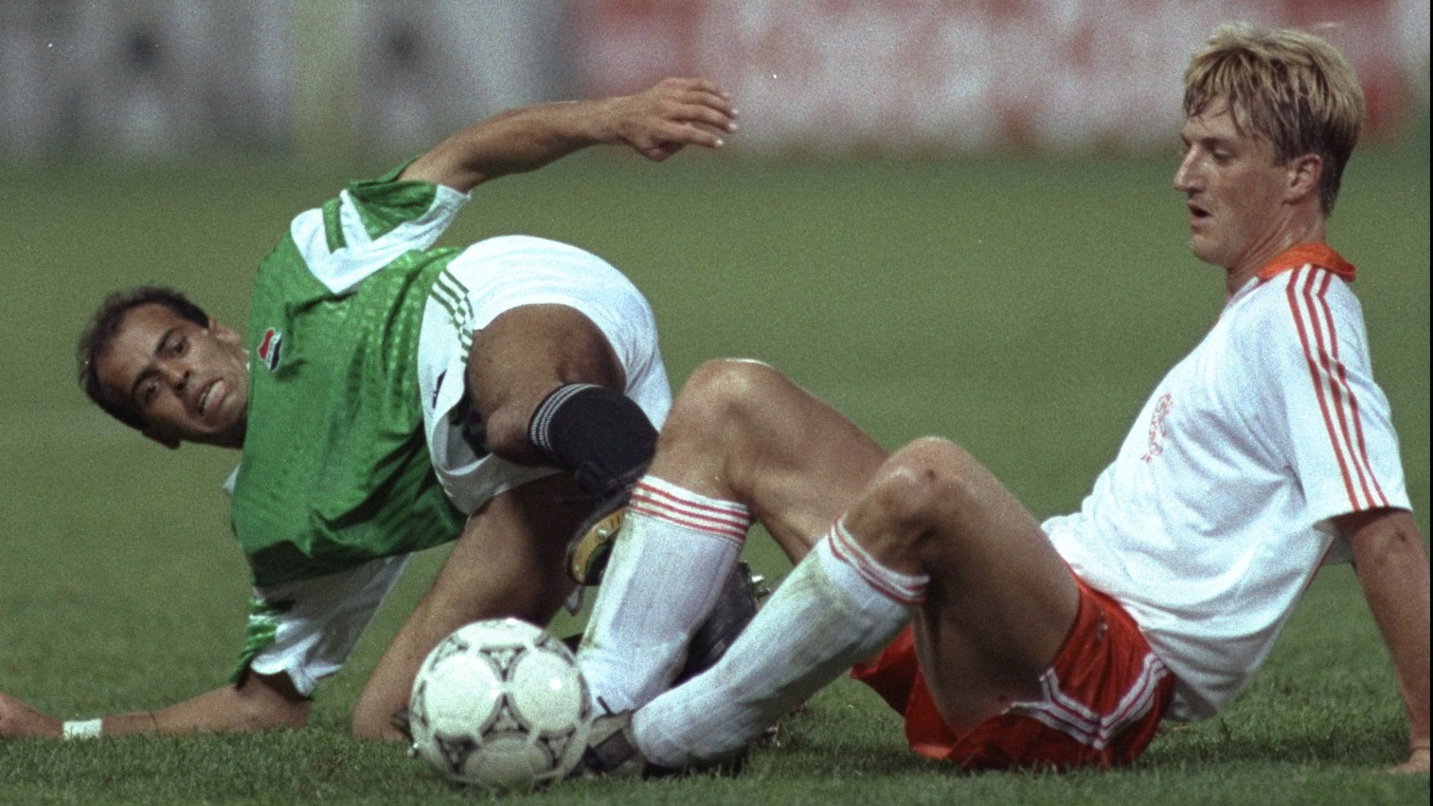 Esham Yakan of Egypt and Williem Kieft of Holland tackle each other for the ball