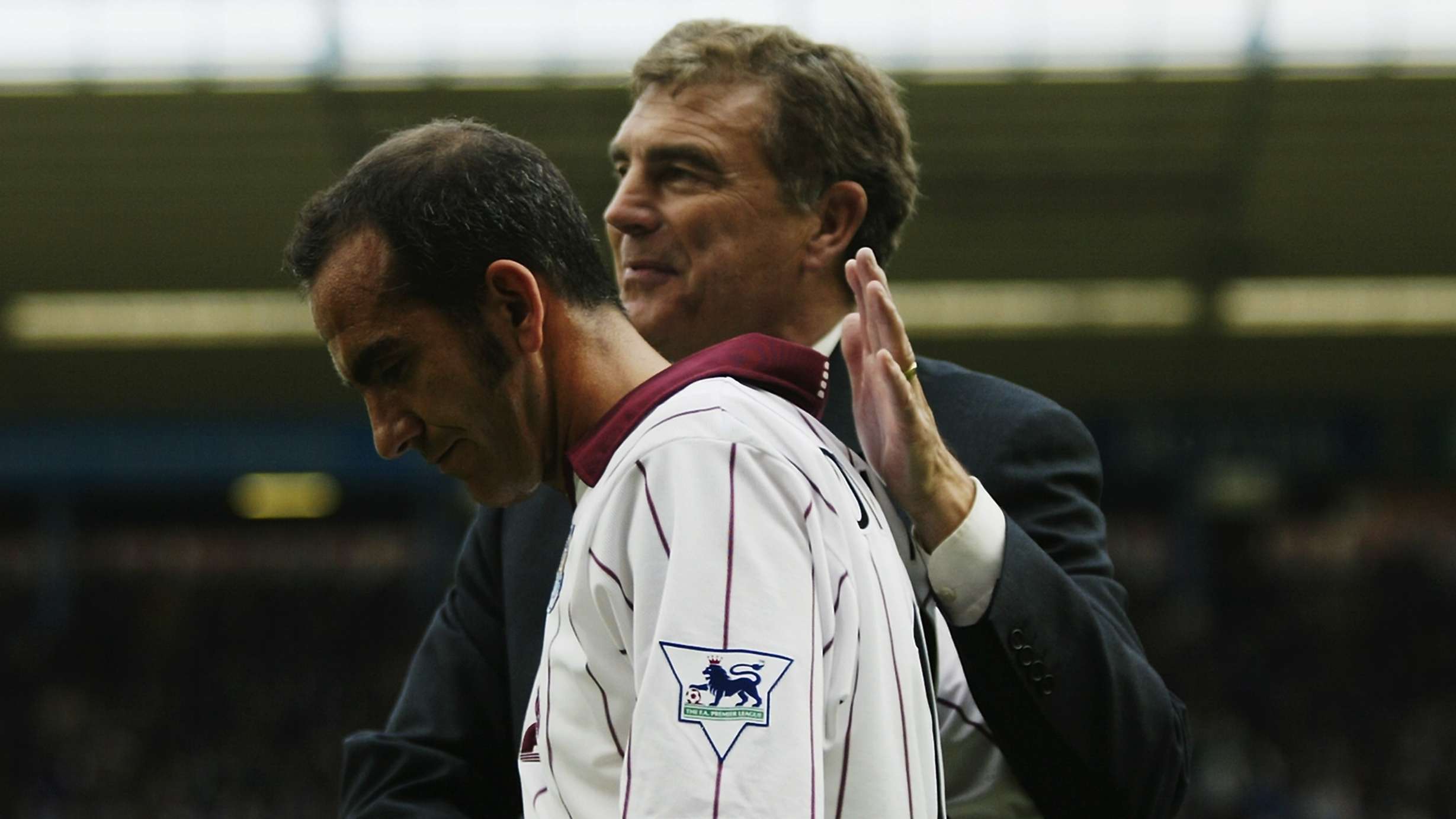 Paulo Di Canio of West Ham United receives a pat on the back from West Ham United caretaker manager Trevor Brooking