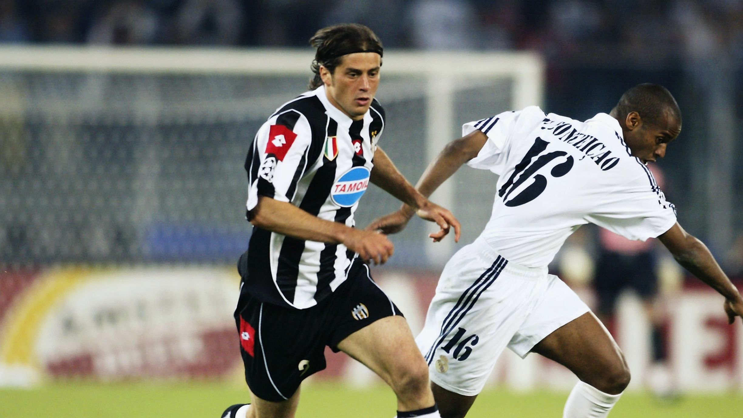 Alessio Tacchinardi of Juventus is tackled by Flavio Conceicao of Real Madrid