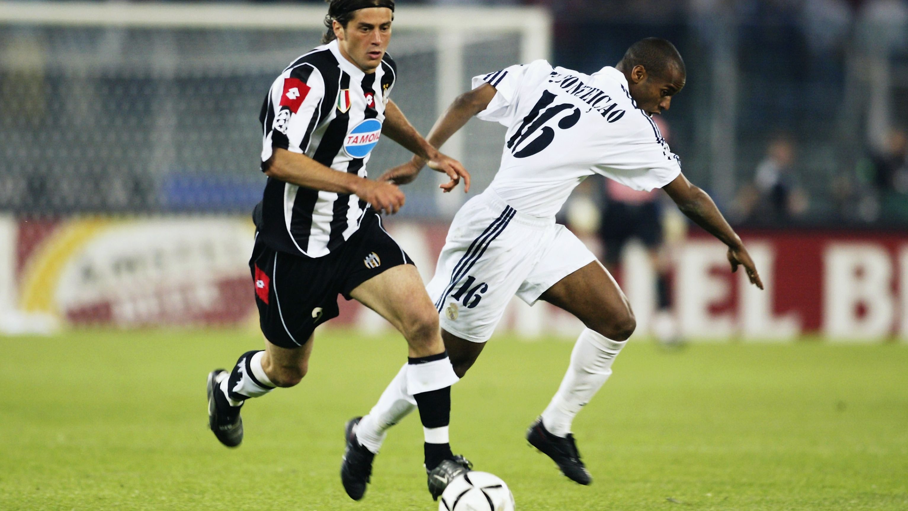 Alessio Tacchinardi of Juventus is tackled by Flavio Conceicao of Real Madrid