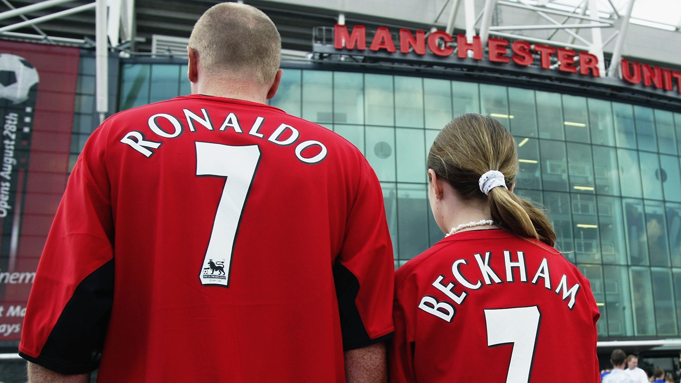 Manchester United fans wearing new boy Cristiano Ronaldo and recently departed David Beckham shirts