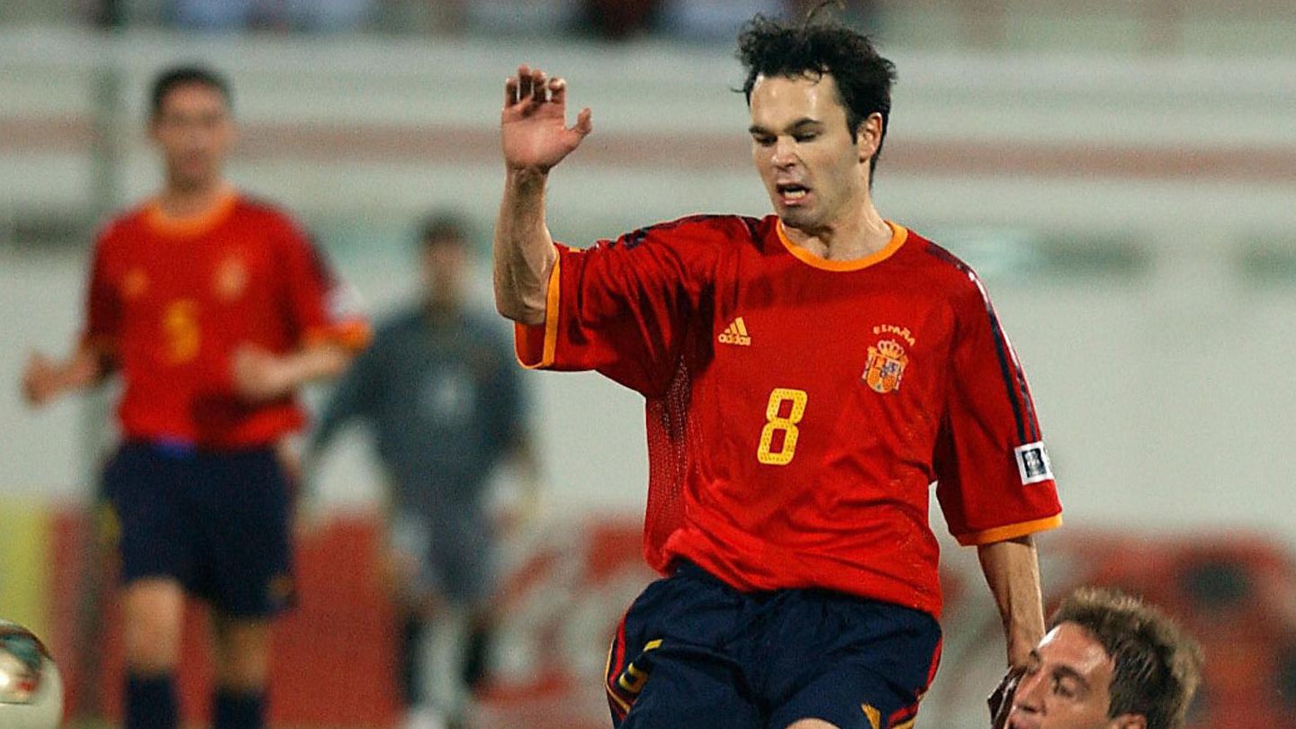 Spaniard Iniesta (standing) is tackled b