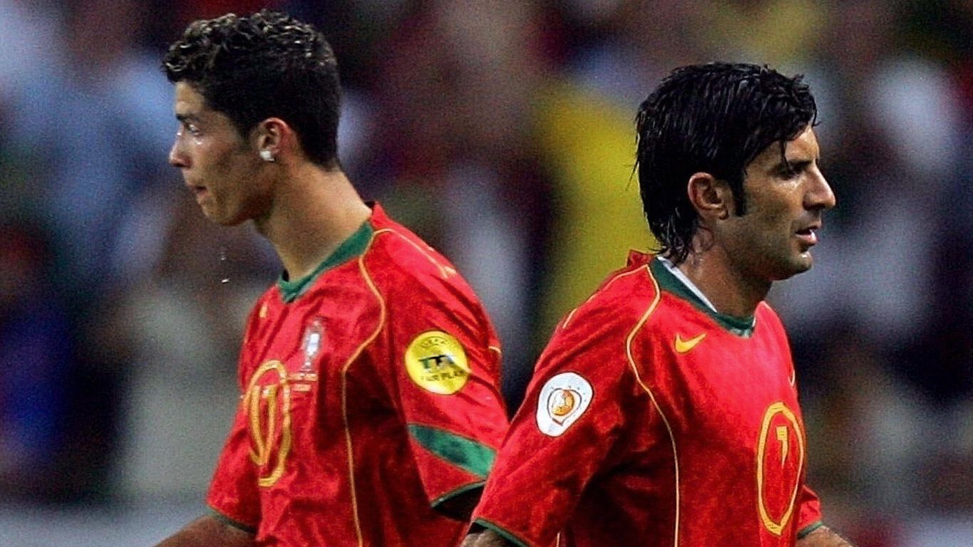 Portugal's forward Luis Figo (R) walks p