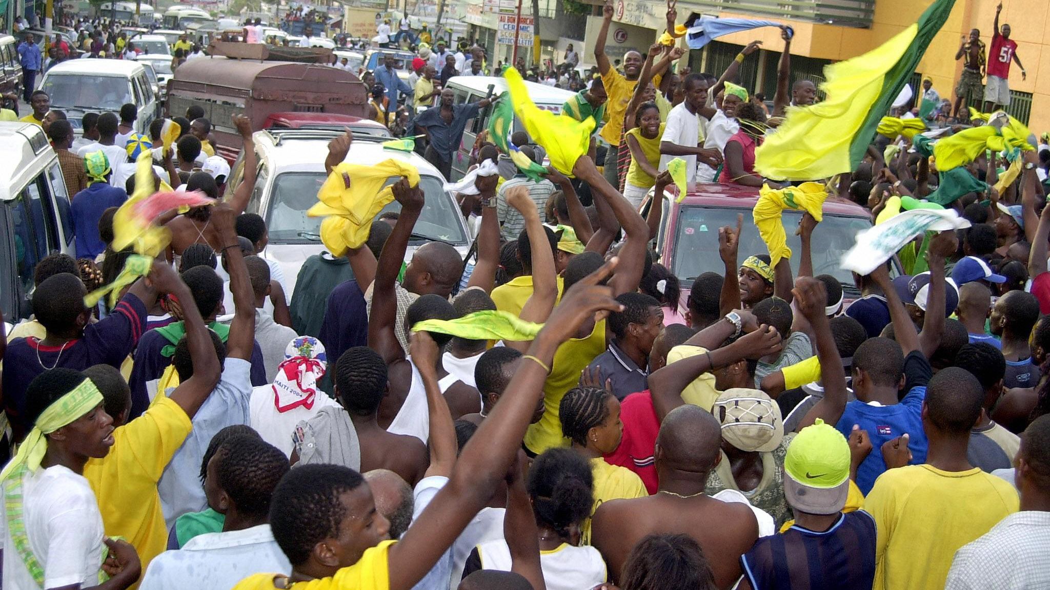 An impromptu parade of Haitians waving B