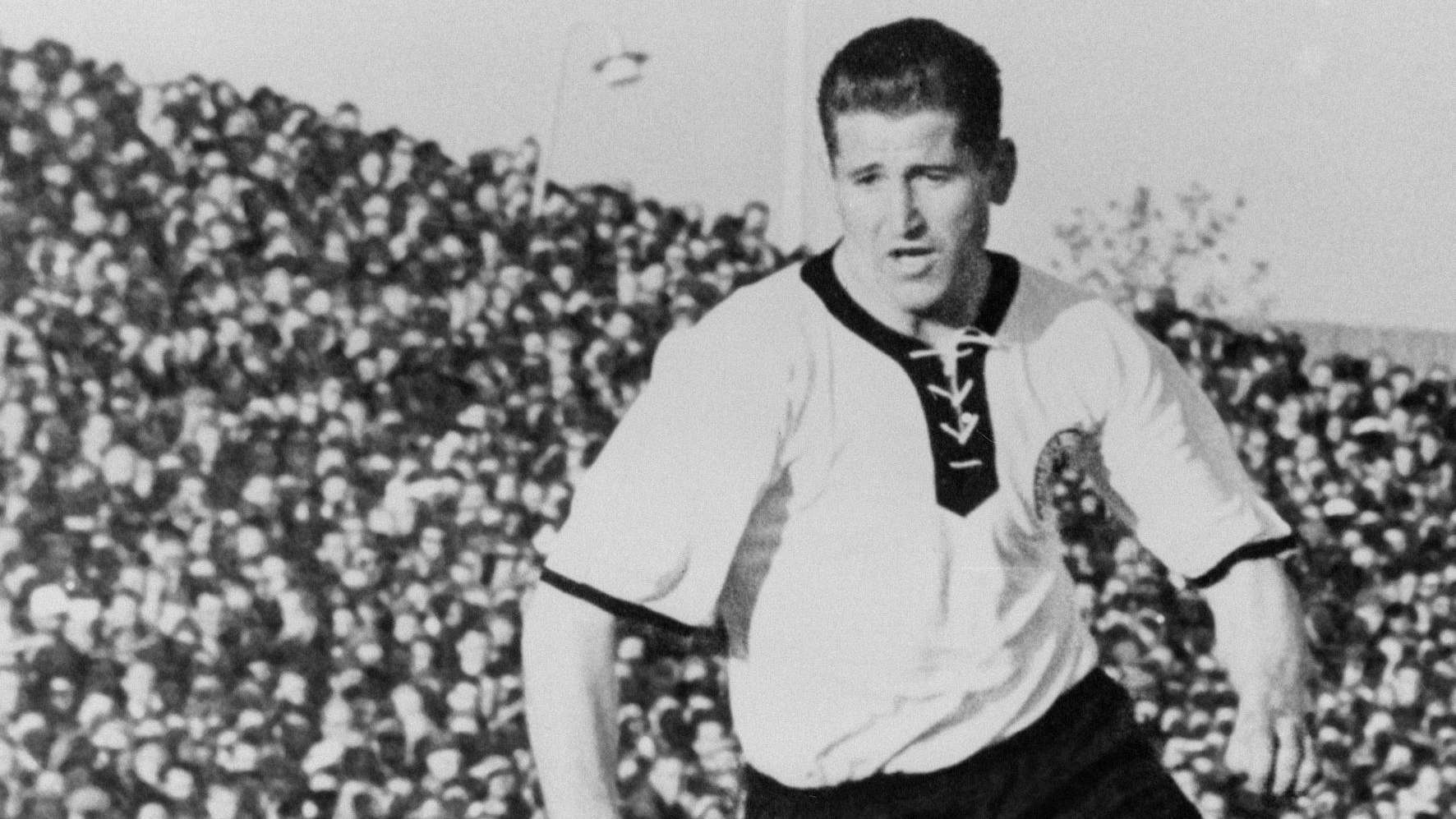 West German forward Helmut Rahn dribbles upfield d