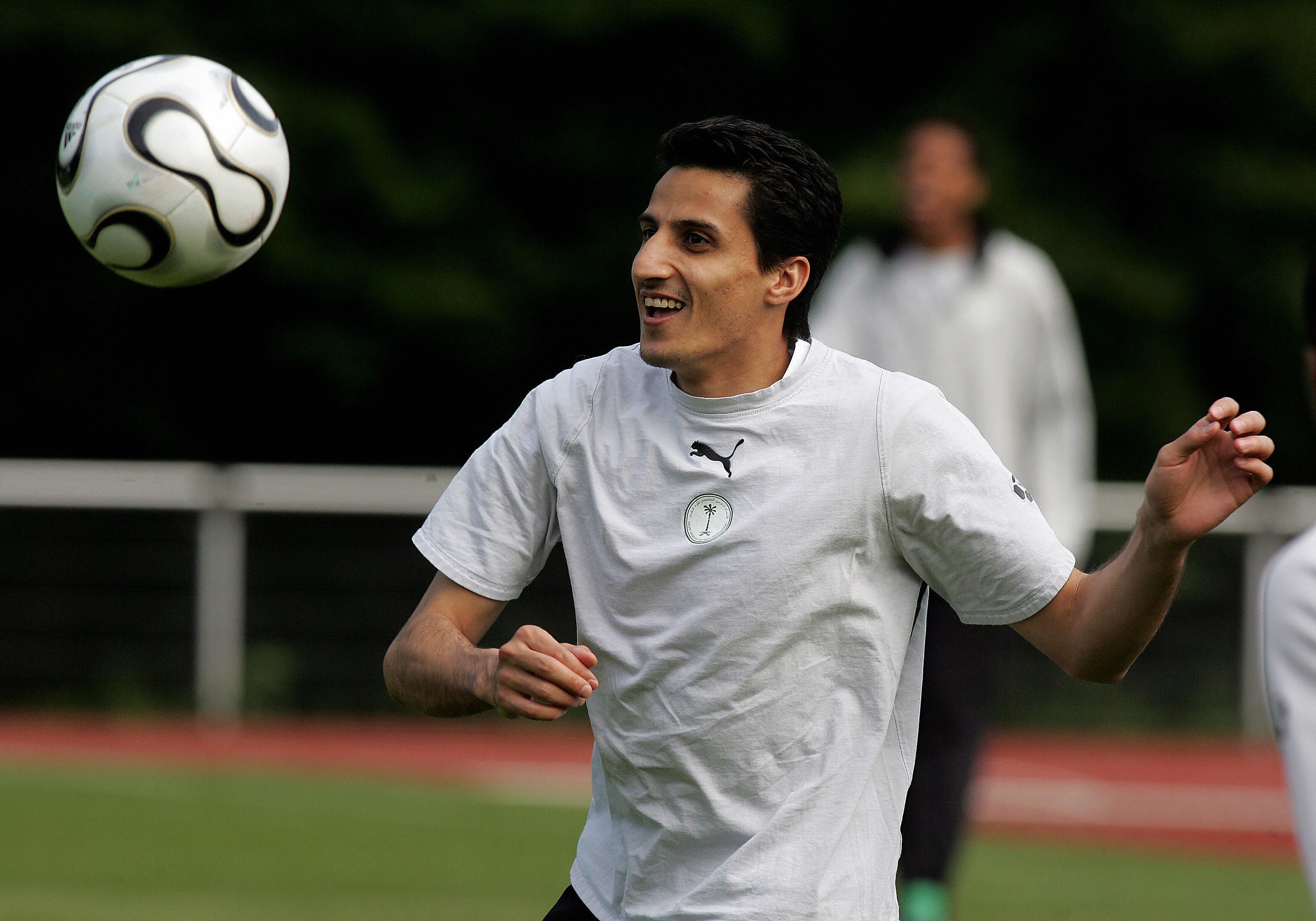 Saudi midfielder Nawaf al-Temyat watches