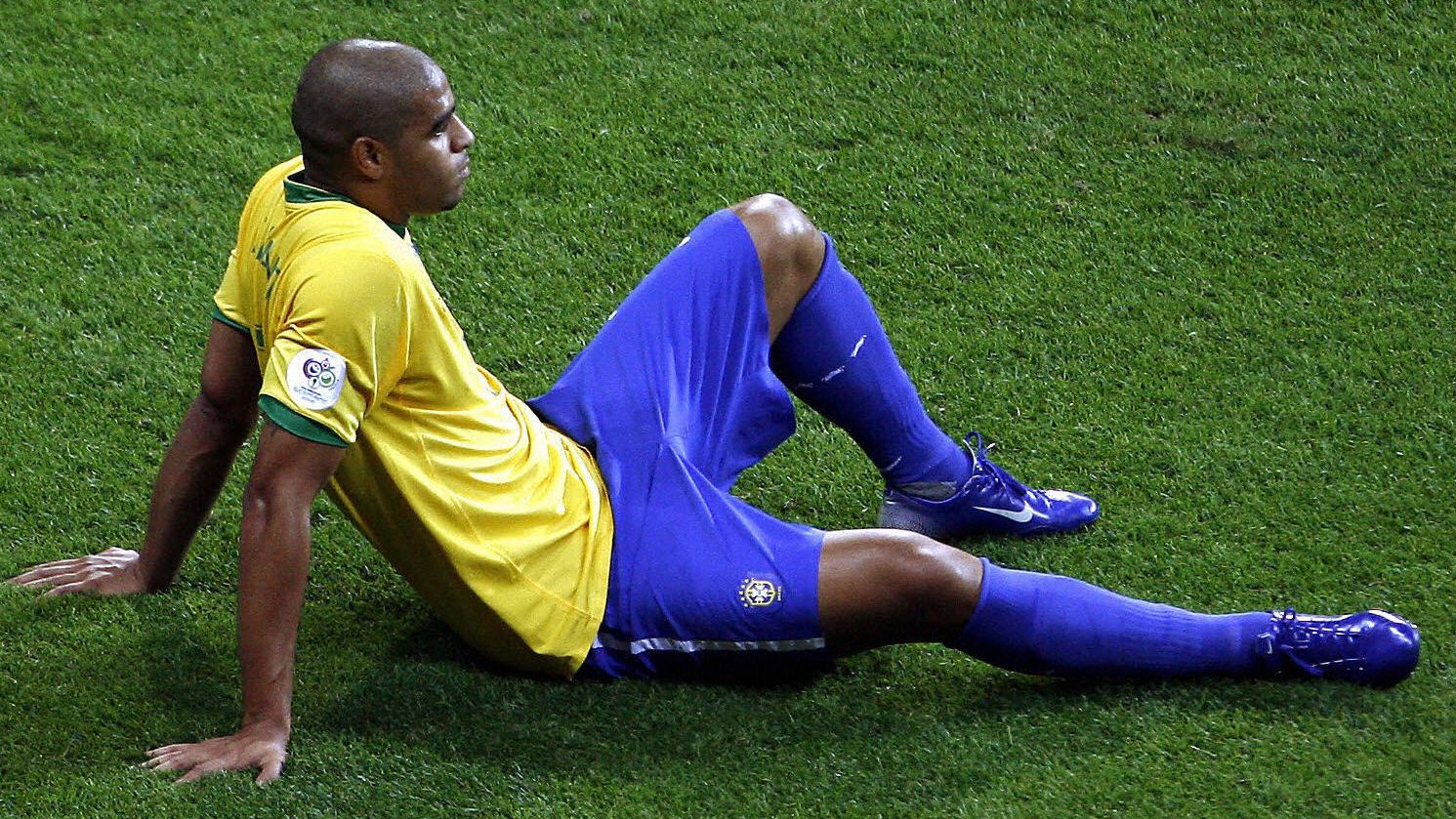 Brazilian player Adriano sits on the fie