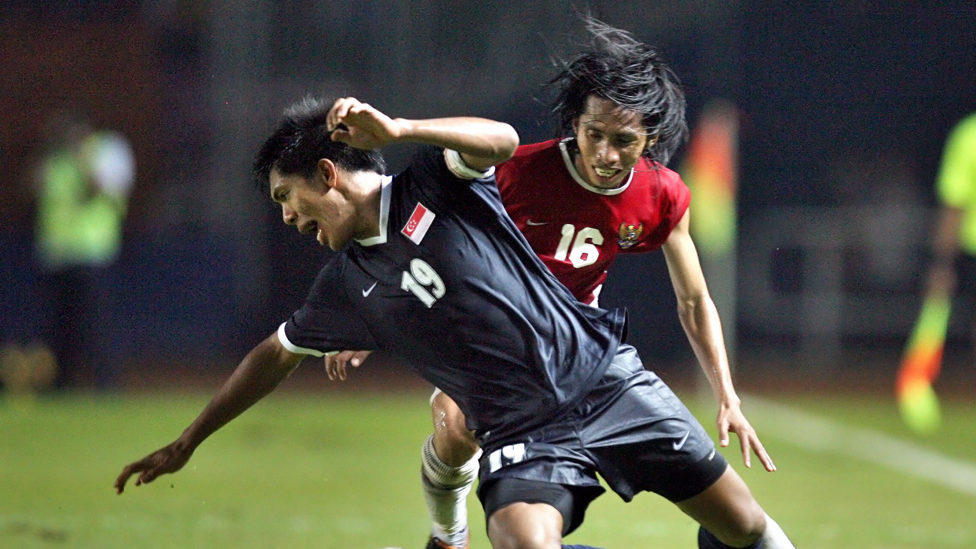 Singapore's captain Kamal (front) is tac...
