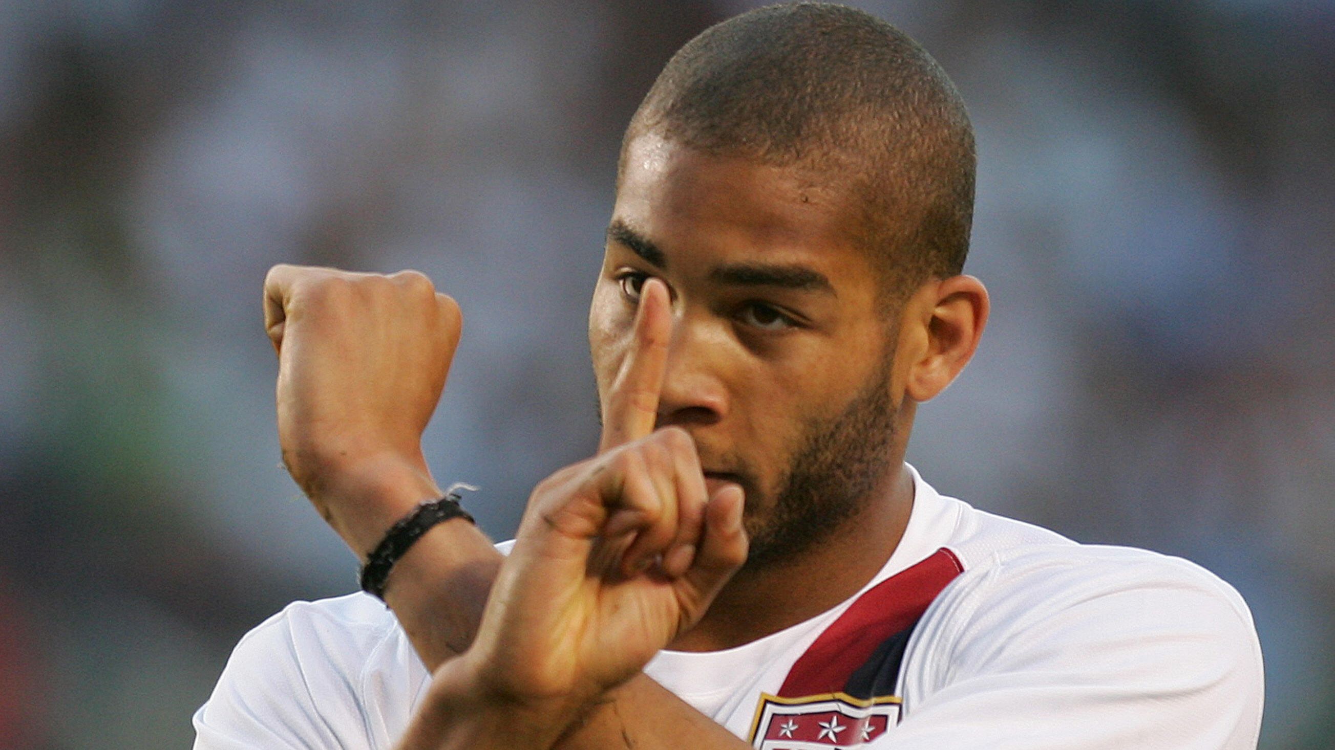 USA's Oguchi Onyewu gestures to the crow...