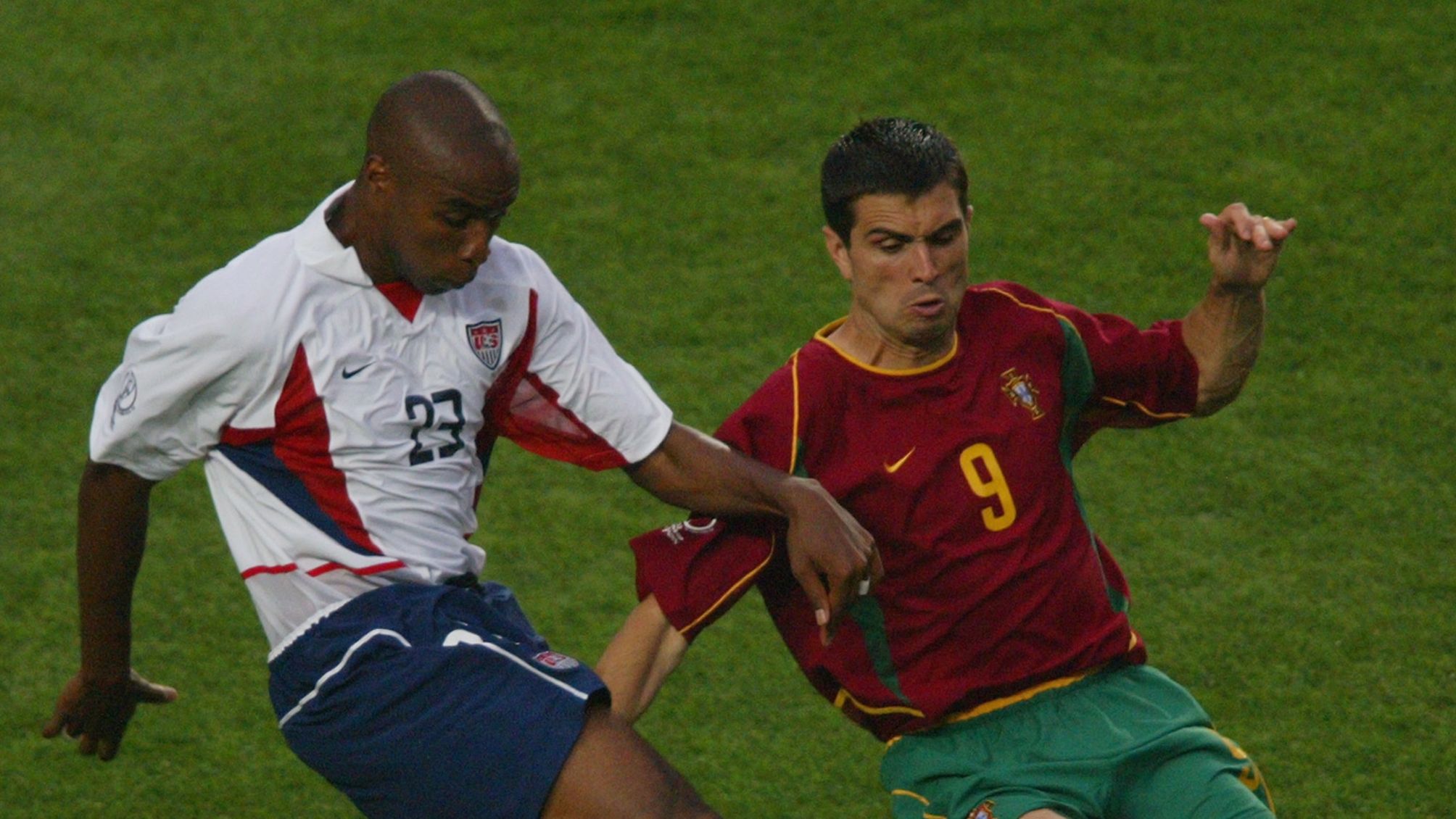 Eddie Pope of the USA is challenged by Pauleta of Portugal