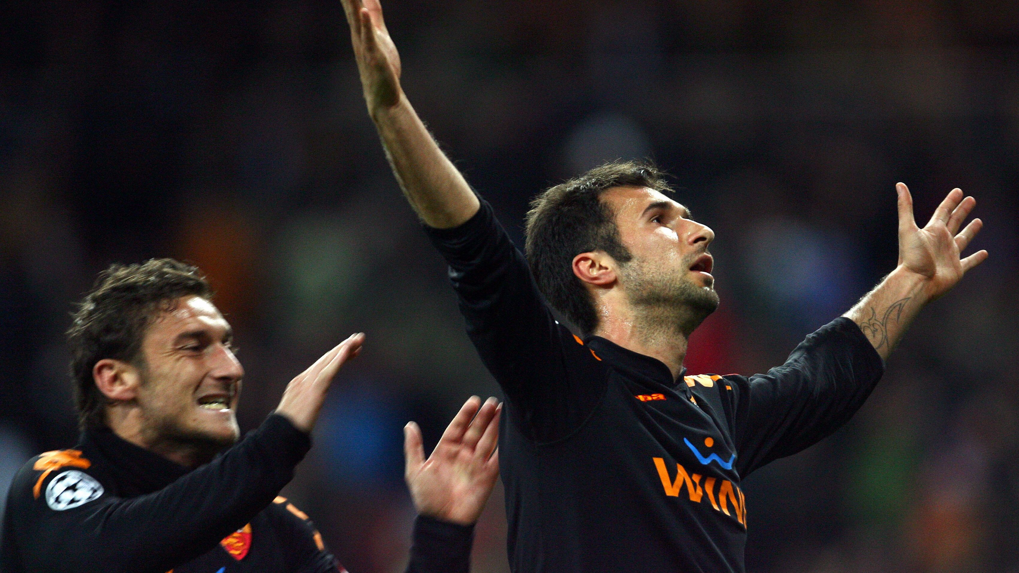 Roma's Mirko Vucinic (R) celebrates with
