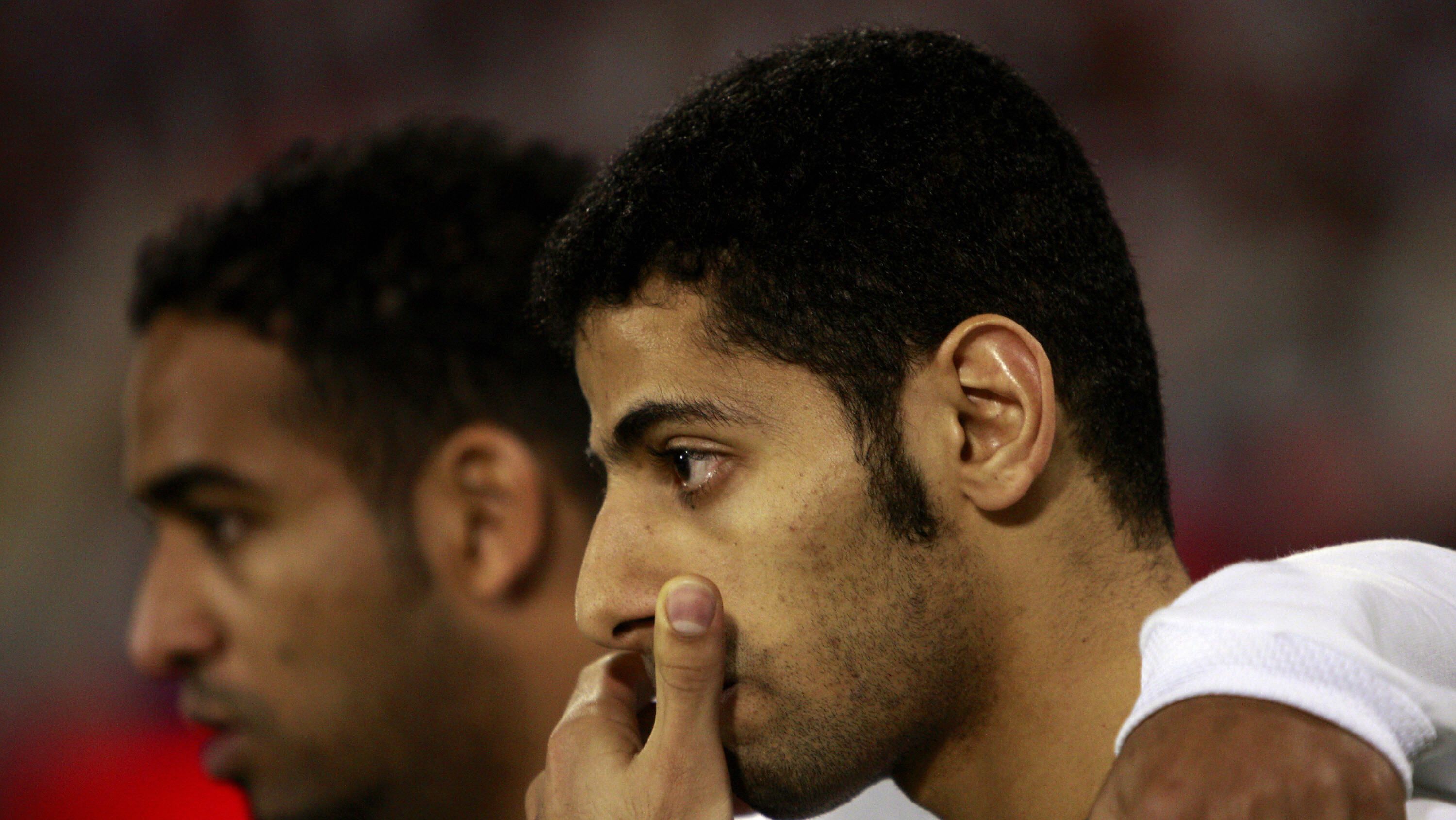 Saudi players Taisir al-Jassim (R) and A