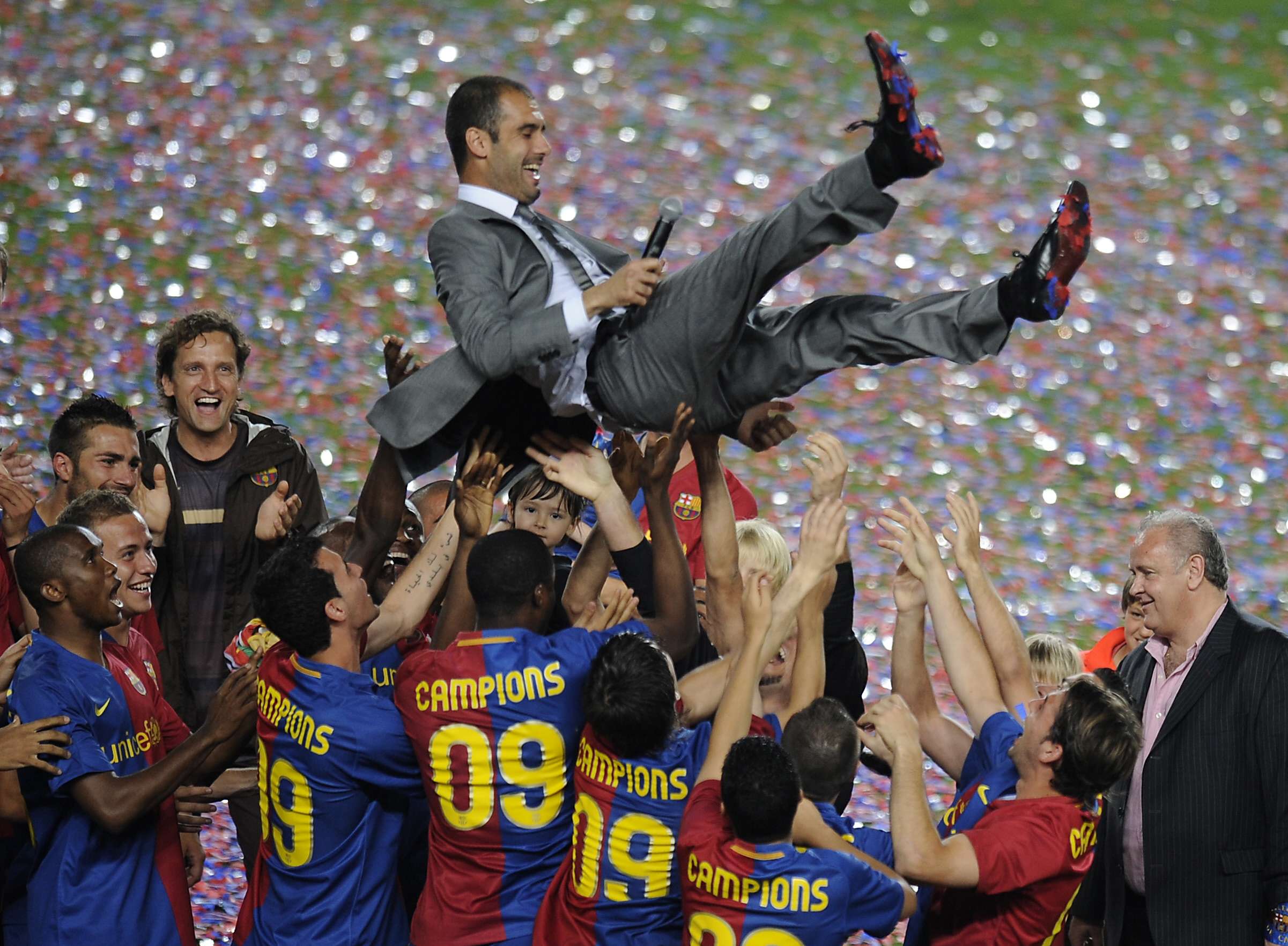 Barcelona players lift their coach Pep G