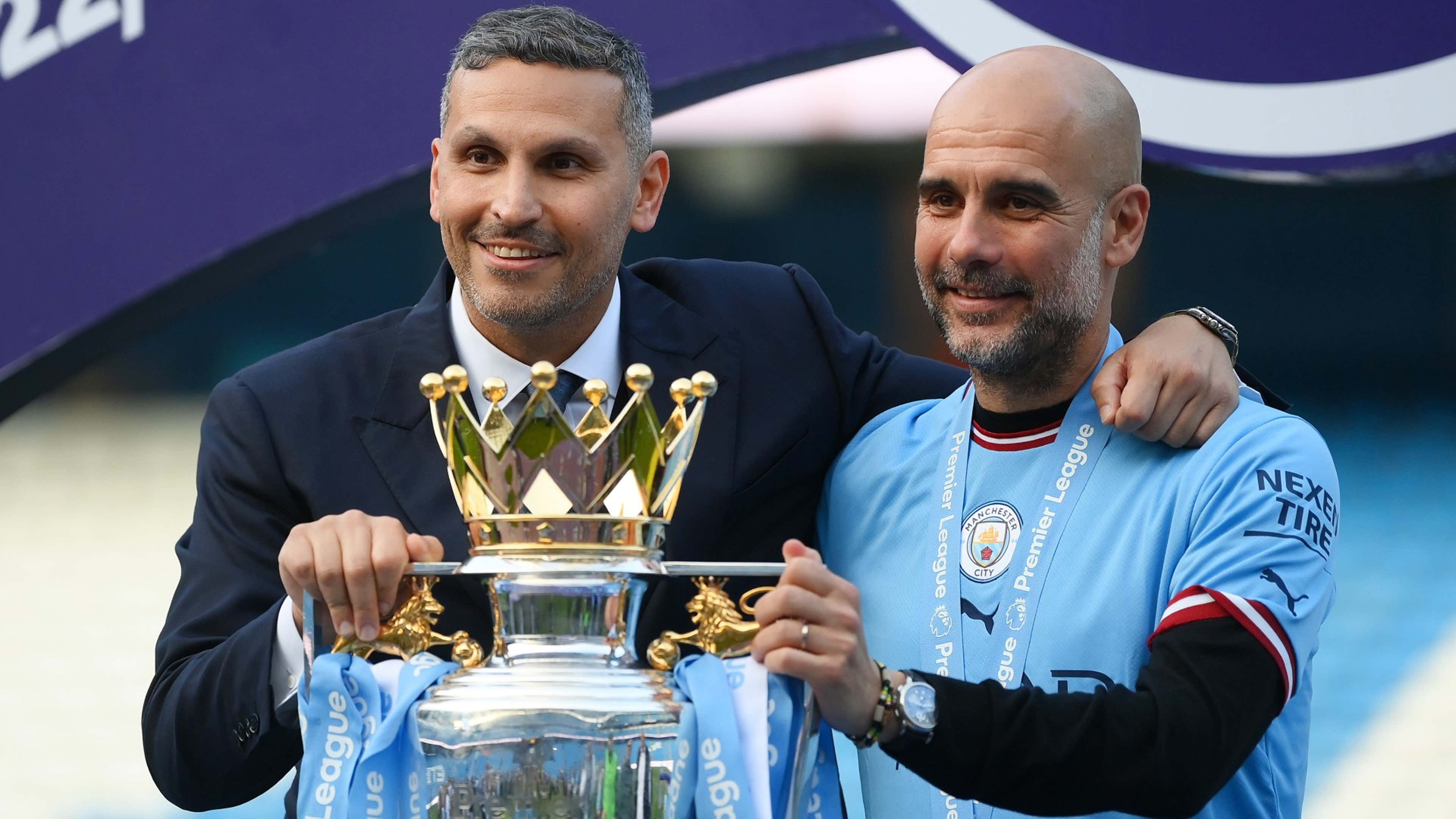 Khaldoon Al Mubarak, Chairman of Manchester City, poses for a photograph with the Premier League Trophy and Pep Guardiola, Manager of Manchester City