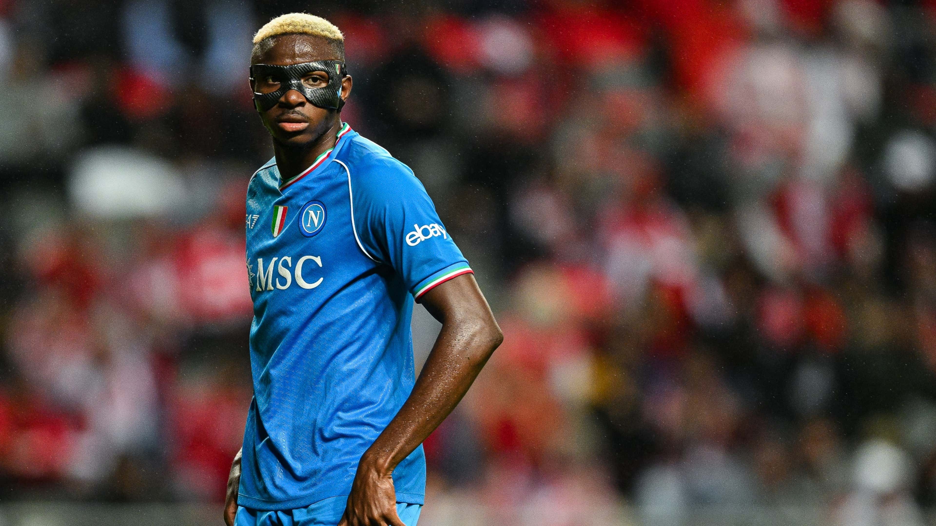  Victor Osimhen, a Nigerian professional footballer who plays as a striker for Serie A club Napoli and the Nigeria national team, wearing a black mask, looks on during a match.