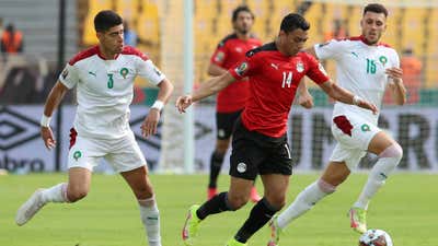 Mostafa Mohamed Ahmed Abdalla of Egypt challenged by Adam Masina and Selim Amallah of Morocco.