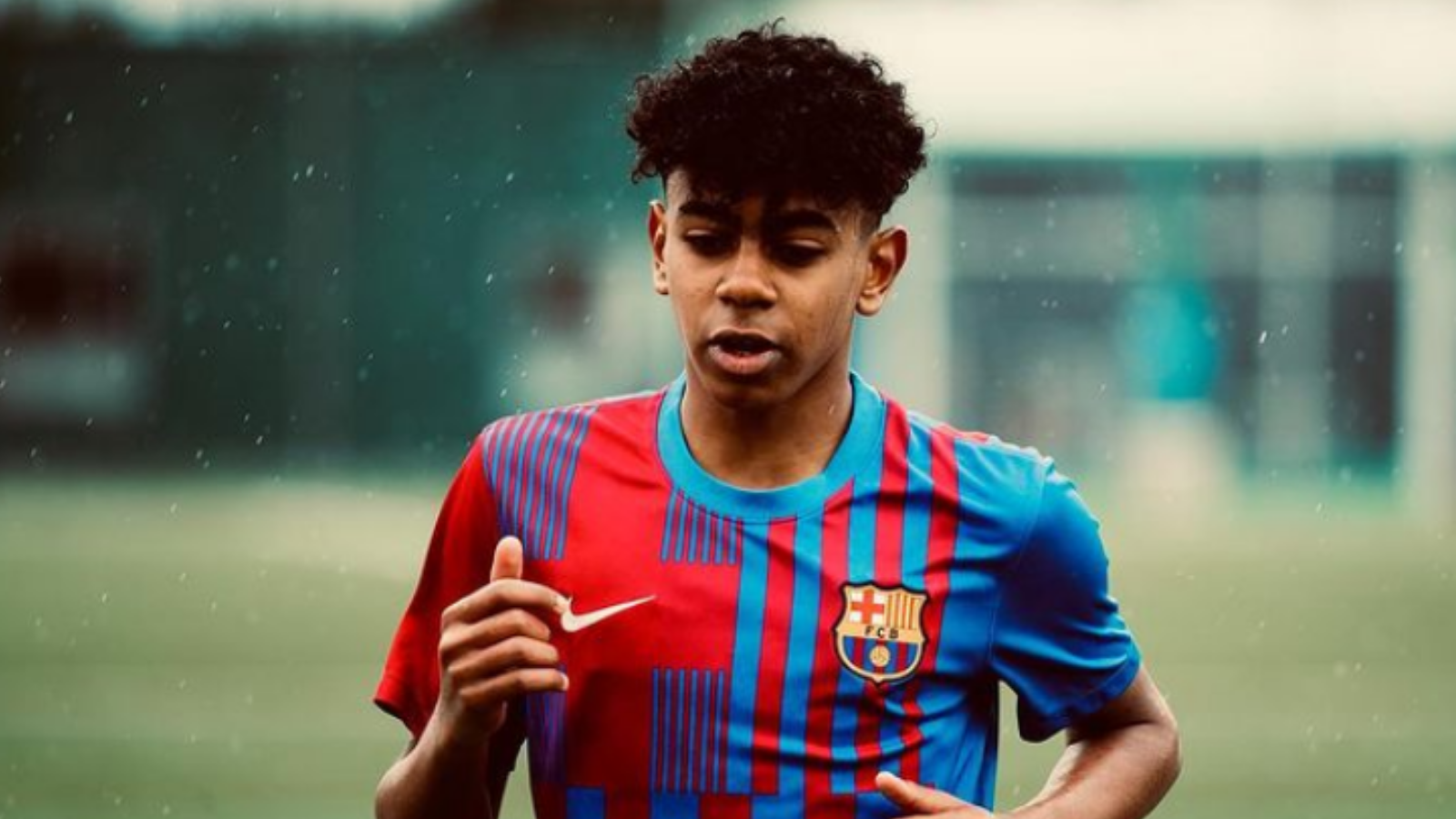  Lamine Yamal, a young soccer player for FC Barcelona, is captured in mid-stride during a match.