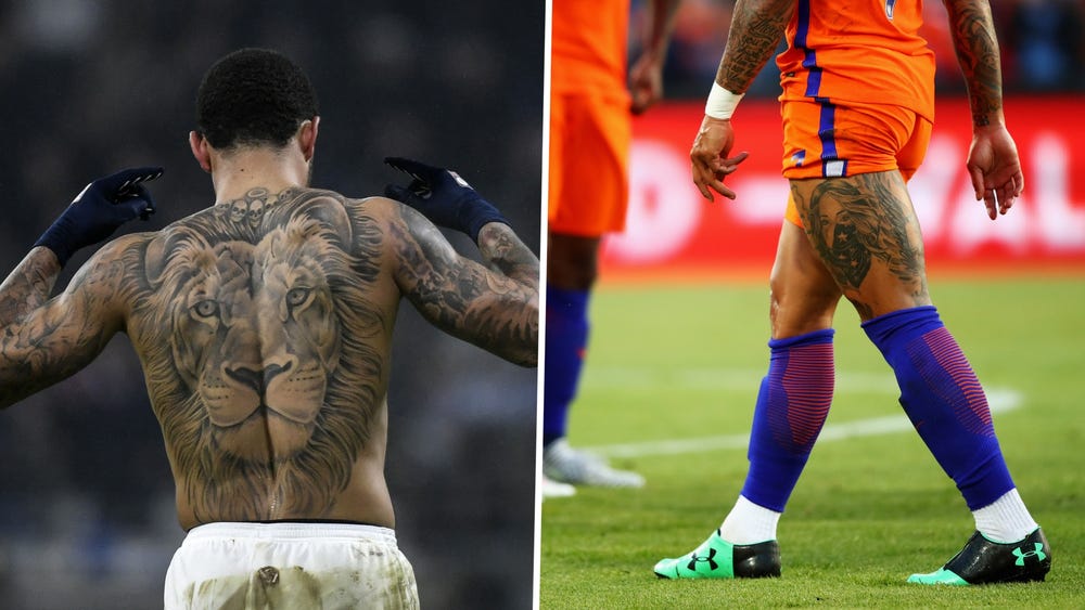 Tattoos are seen on the legs of Memphis Depay of Olympique