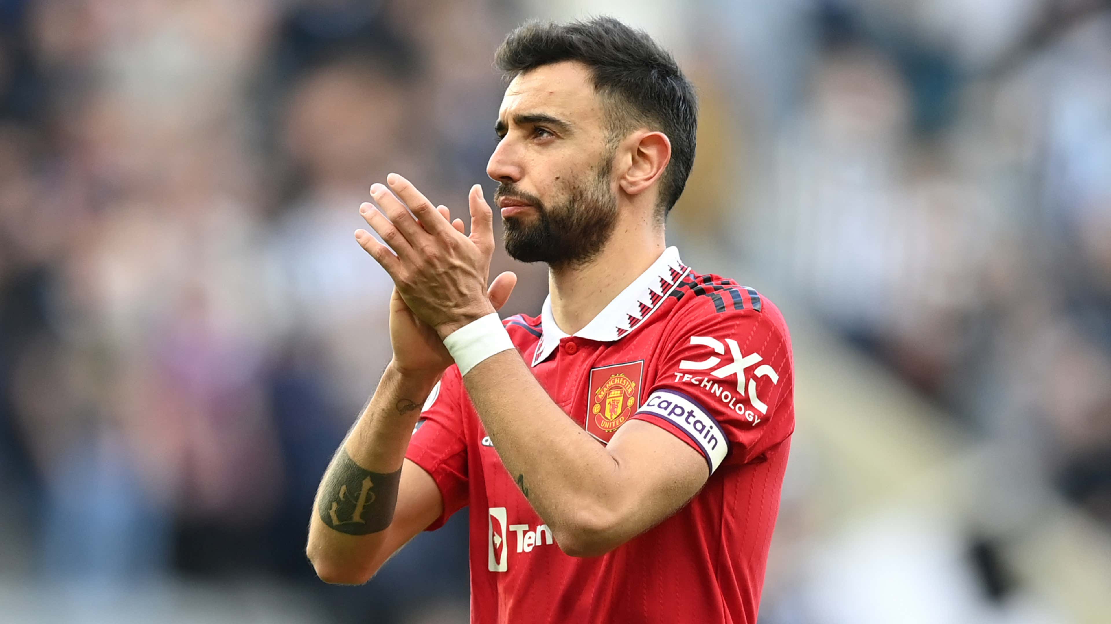  Bruno Fernandes, wearing a red Manchester United shirt with the captain's armband, applauds the crowd after creating another goal scoring opportunity for his team in the Premier League.