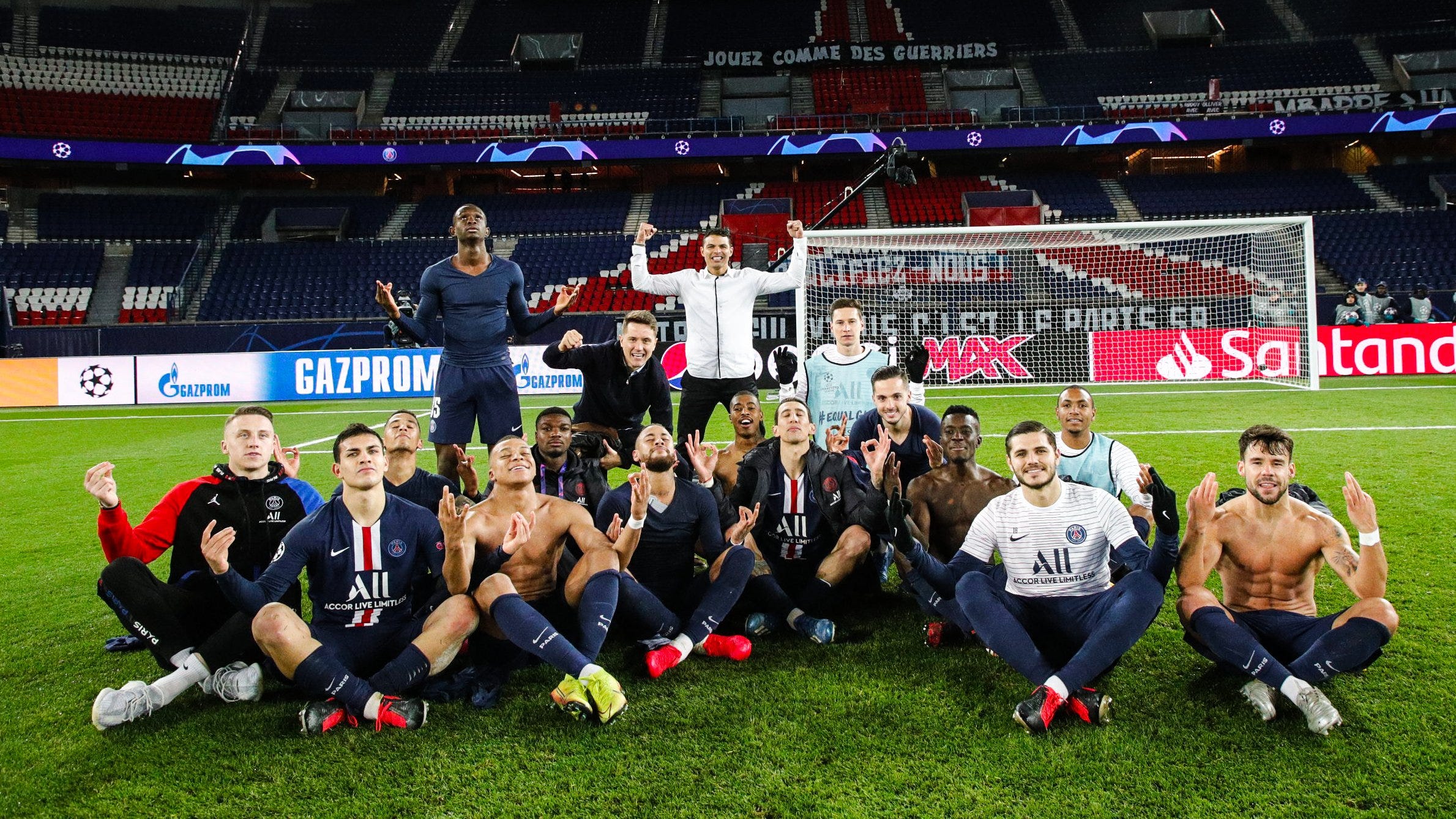  The image shows several Paris Saint Germain football players celebrating a victory in a match against Borussia Dortmund in the Parc des Princes stadium.