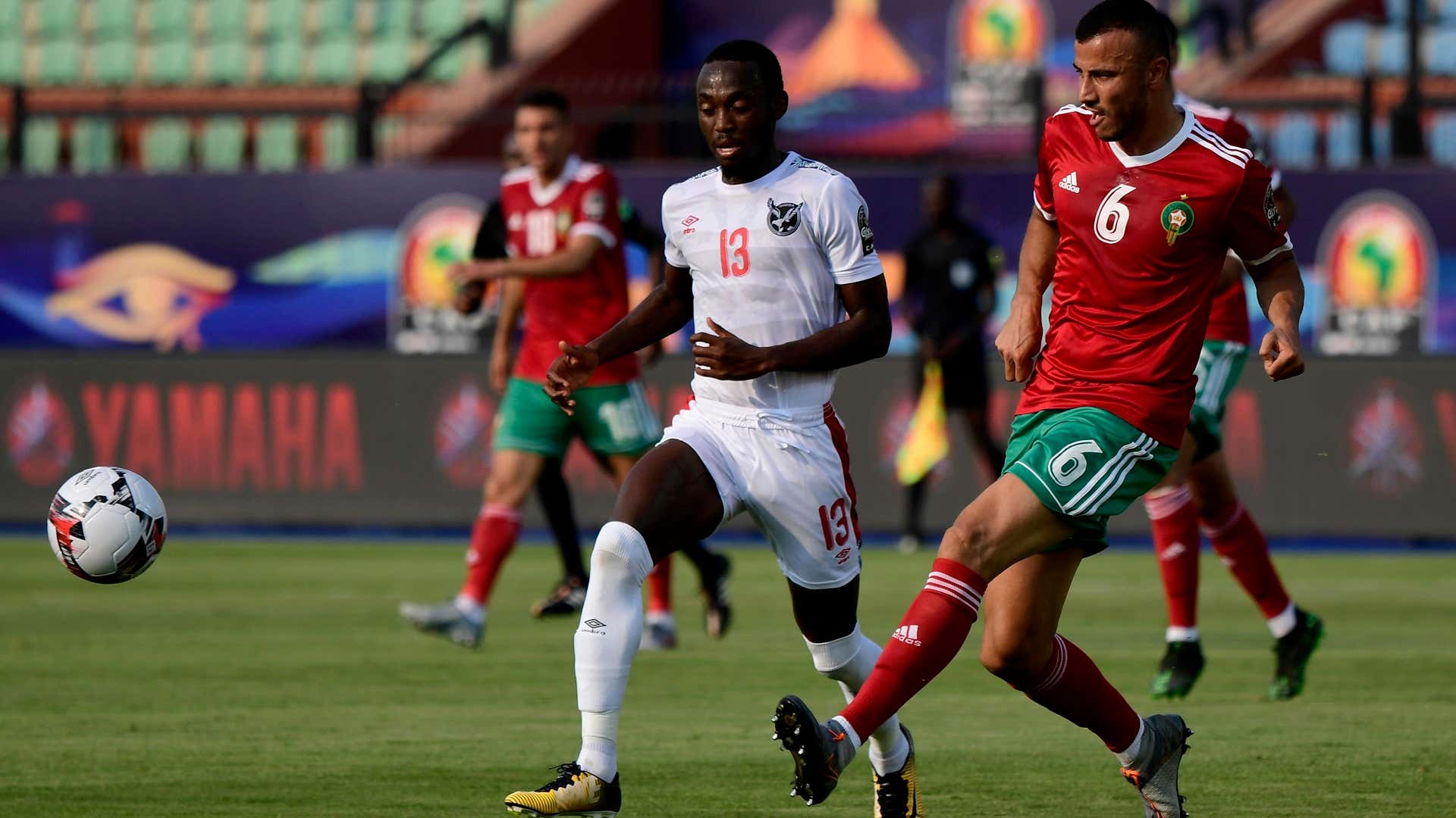 Morocco's defender Romain Saiss (R) passes the ball as he is marked by Namibia's forward Peter Shalulile during the 2019 Africa Cup of Nations